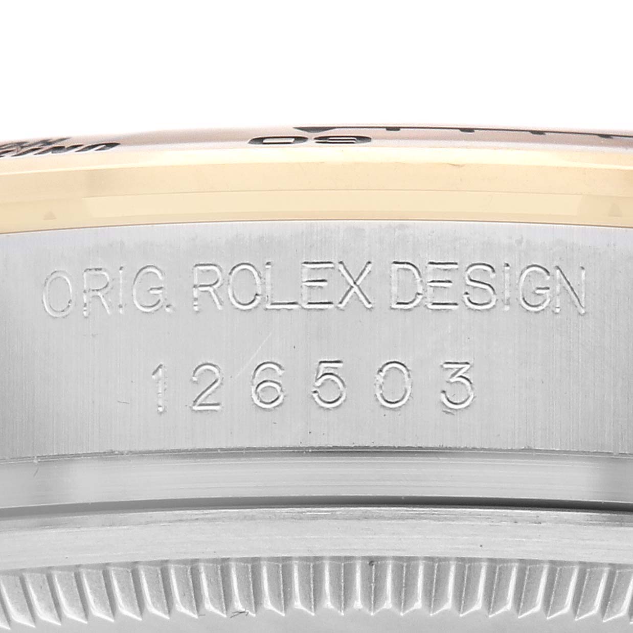 The image shows a close-up side view of the Rolex Daytona 126503 Men
s Steel and Gold (two tone) Champagne Dial model
s bezel area, displaying "O.RIG. ROLEX DESIGN" and a model number.
