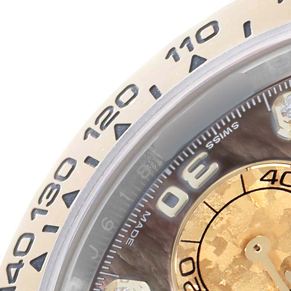 The image shows a close-up of the bezel and part of the dial of a Rolex Daytona 116503 Men
s Steel and Gold (two tone) Mother of Pearl Dial watch, highlighting the tachymetric scale and markers.