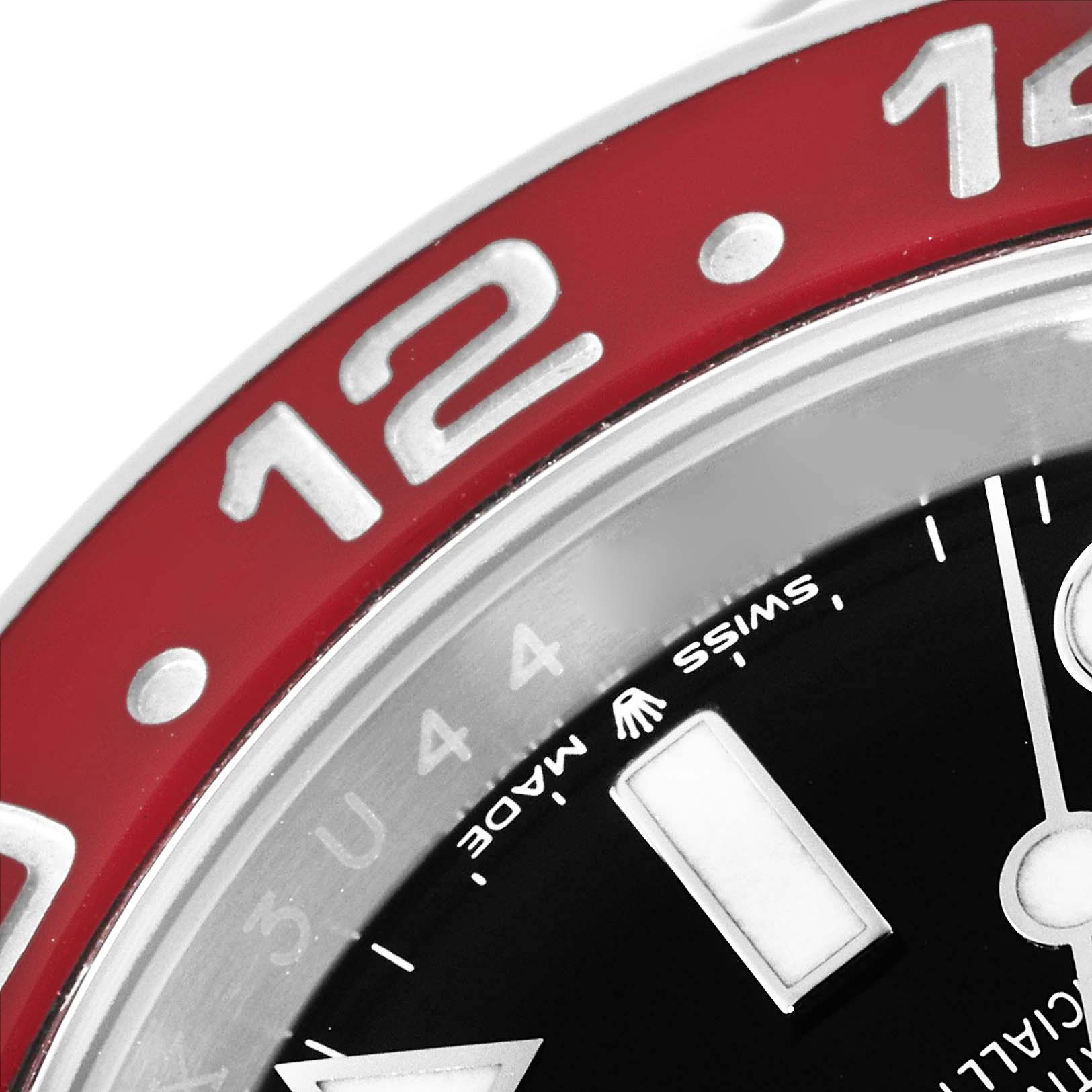 Close-up of a Rolex GMT-Master 126710 Men's Stainless Steel Black Dial 126710 Men's Stainless Steel Black Dial watch showing the red bezel with "12" marking and part of the black dial with "Swiss Made".