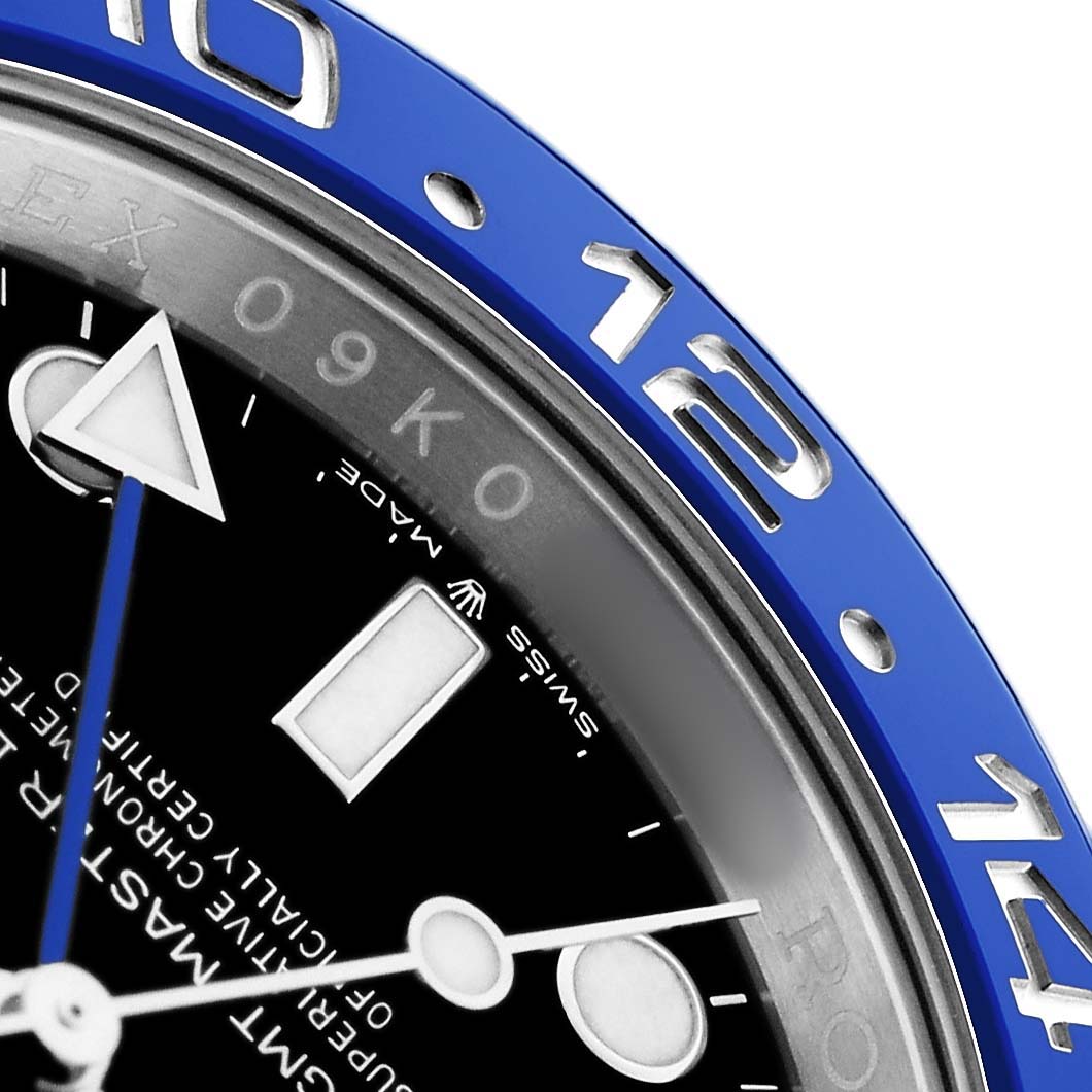 The image shows a close-up of the Rolex GMT-Master 126710BLNR Men
s Stainless Steel Black Dial bezel and part of the dial, including hour markers and hands.