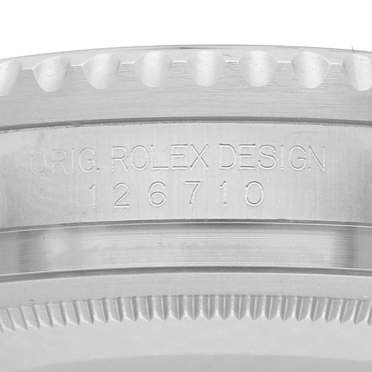 The image shows a close-up of the side of a Rolex GMT-Master 126710BLNR Men
s Stainless Steel Black Dial watch case, highlighting the model number engraving.