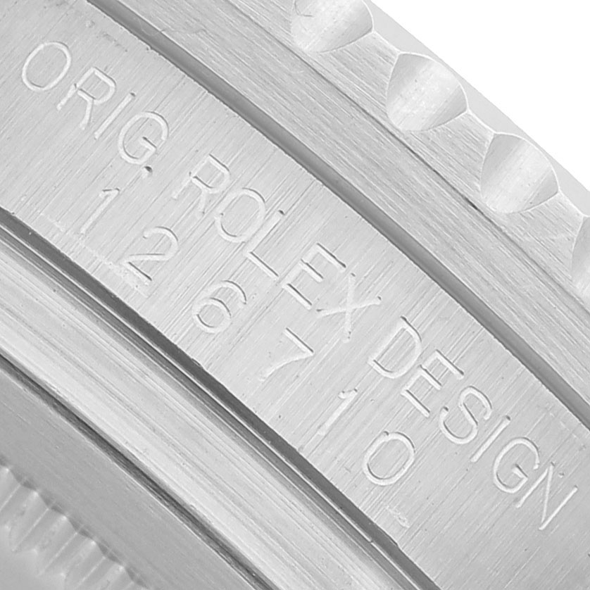 The image shows the engraved side of the bezel of a Rolex GMT-Master 126710BLRO Men's Stainless Steel Black Dial, featuring model and design details.