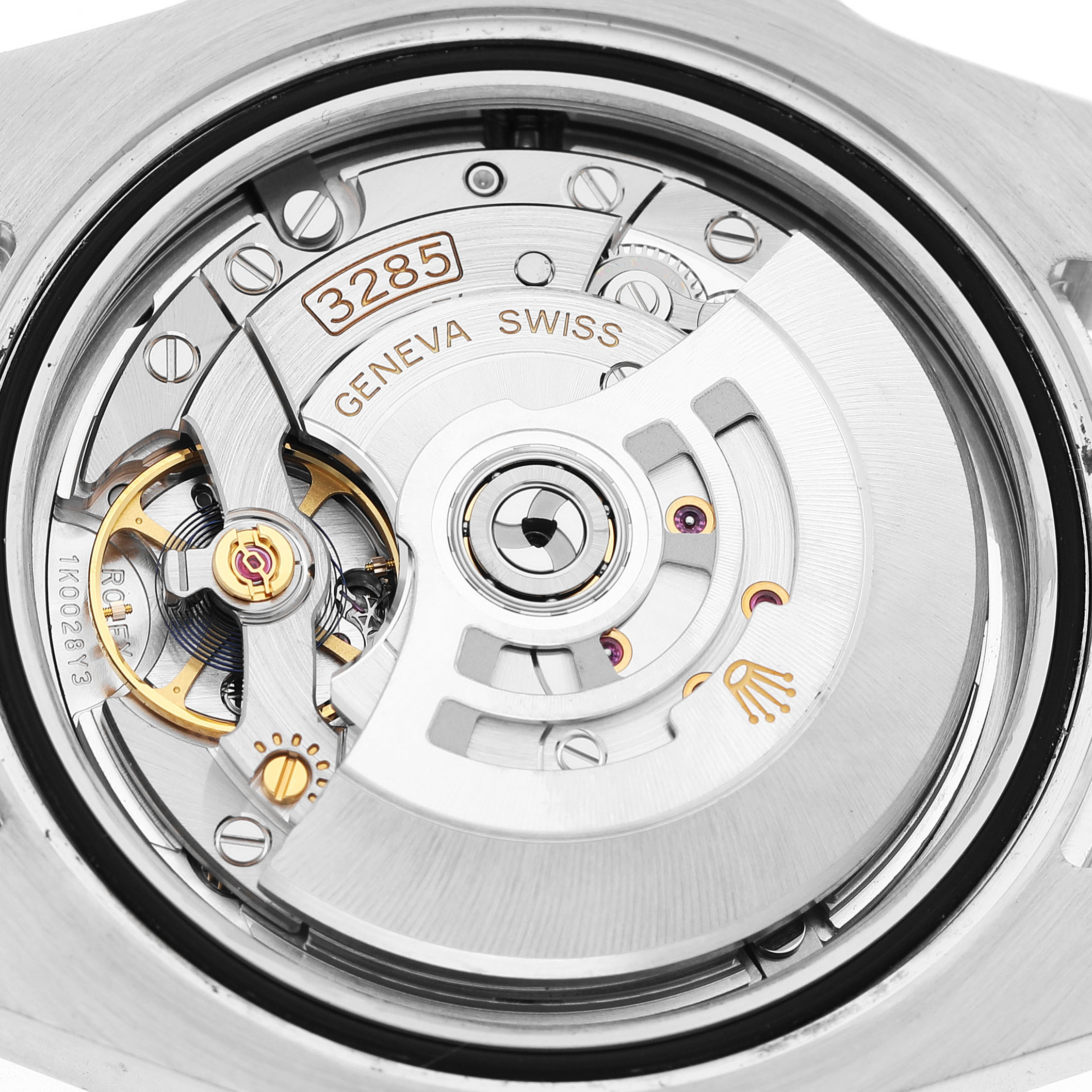 The image shows a close-up of the movement and rotor of a Rolex GMT-Master 126710BLRO Men's Stainless Steel Black Dial watch, focusing on the intricate mechanical parts.