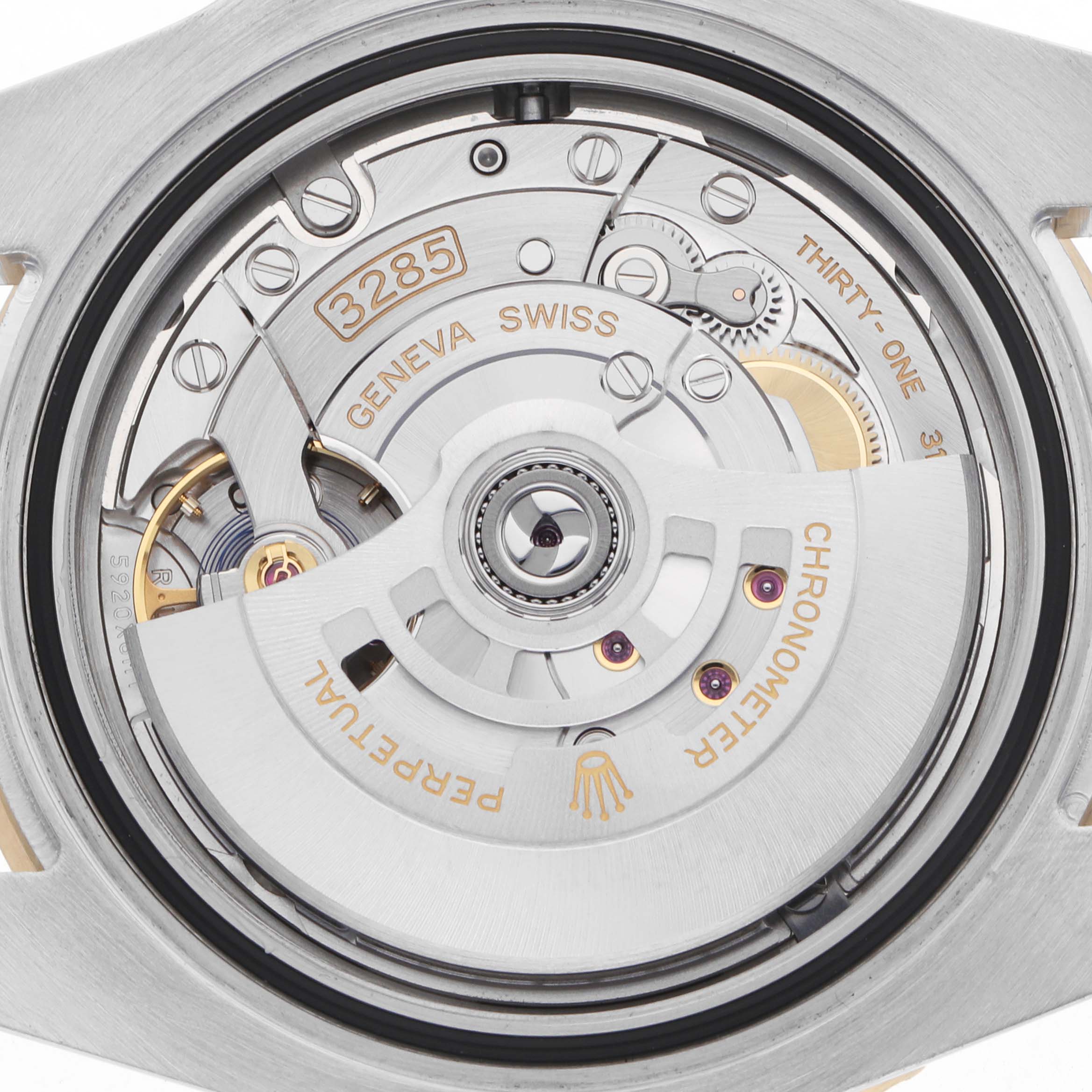 The image shows the movement of a Rolex GMT-Master 126713 Men
s Steel and Gold (two tone) Black Dial watch, specifically highlighting the rotor and intricate inner components.