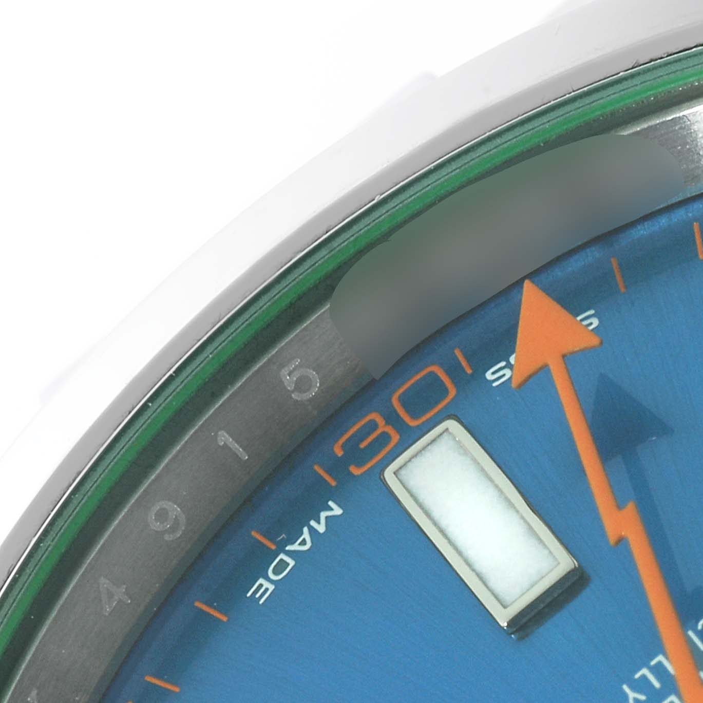 The image shows a close-up of the dial and bezel of a Rolex Milgauss 116400GV Men
s Stainless Steel Blue Dial 116400GV Men
s Stainless Steel Blue Dial watch, highlighting the minute markers and orange lightning bolt seconds hand.