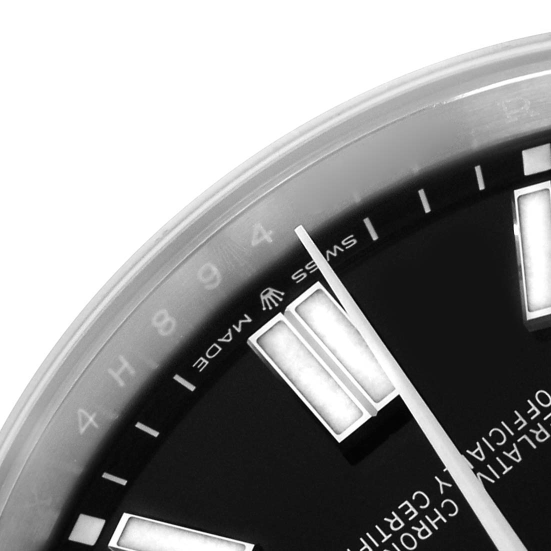 The image shows a close-up of the dial and hands of a Rolex Oyster Perpetual 124300 Men
s Stainless Steel Black Dial, highlighting the markers and details at an angled view.