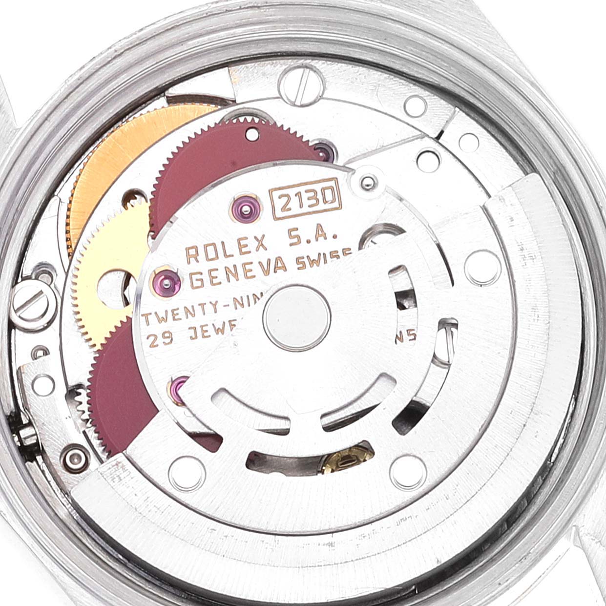 This image shows a close-up of the movement mechanism of a Rolex Oyster Perpetual 67193 Women
s Steel and Gold (two tone) Champagne Dial 67193 Women
s Steel and Gold (two tone) Champagne Dial watch, highlighting the gears and inscriptions.