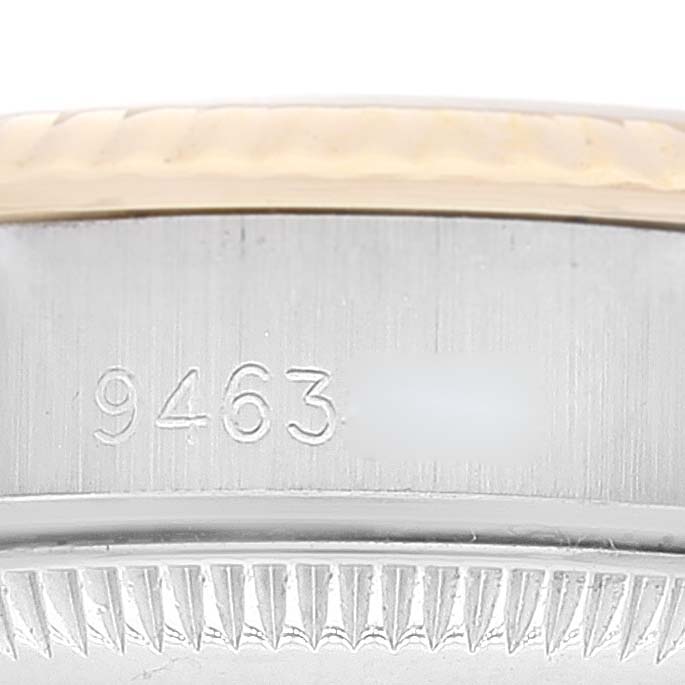 This is a close-up of the side of a Rolex Oyster Perpetual 67193 Women
s Steel and Gold (two tone) Champagne Dial 67193 Women
s Steel and Gold (two tone) Champagne Dial watch showing part of the serial number.
