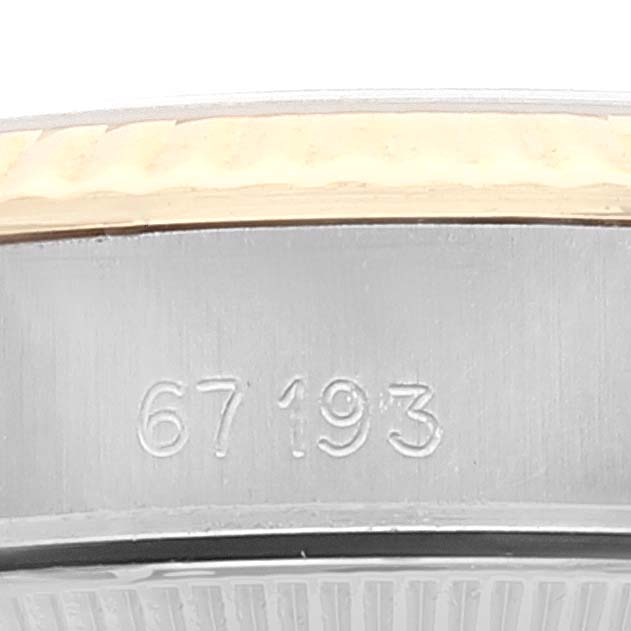 This is a close-up image showing the serial number on the side case of a Rolex Oyster Perpetual 67193 Women
s Steel and Gold (two tone) Champagne Dial 67193 Women
s Steel and Gold (two tone) Champagne Dial watch.