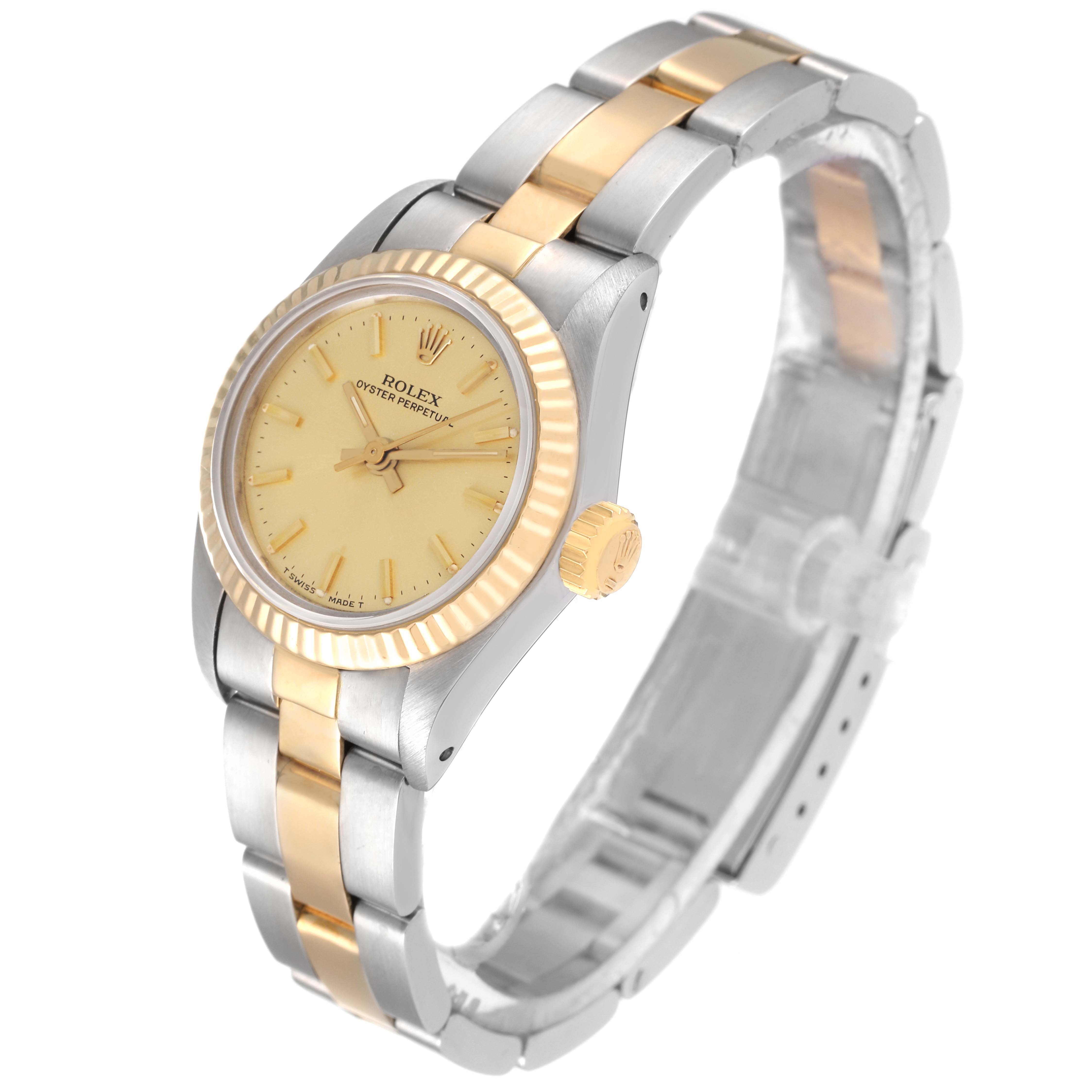 The image shows a side angle of a Rolex Oyster Perpetual 67193 Women
s Steel and Gold (two tone) Champagne Dial 67193 Women
s Steel and Gold (two tone) Champagne Dial watch, highlighting its bezel, dial, crown, and two-tone bracelet.
