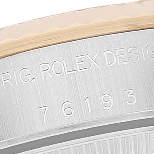 Close-up of the bezel and engraved serial number of a Rolex Oyster Perpetual 76193 Women's Steel and Gold (two tone) Silver Dial 76193 Women's Steel and Gold (two tone) Silver Dial model.