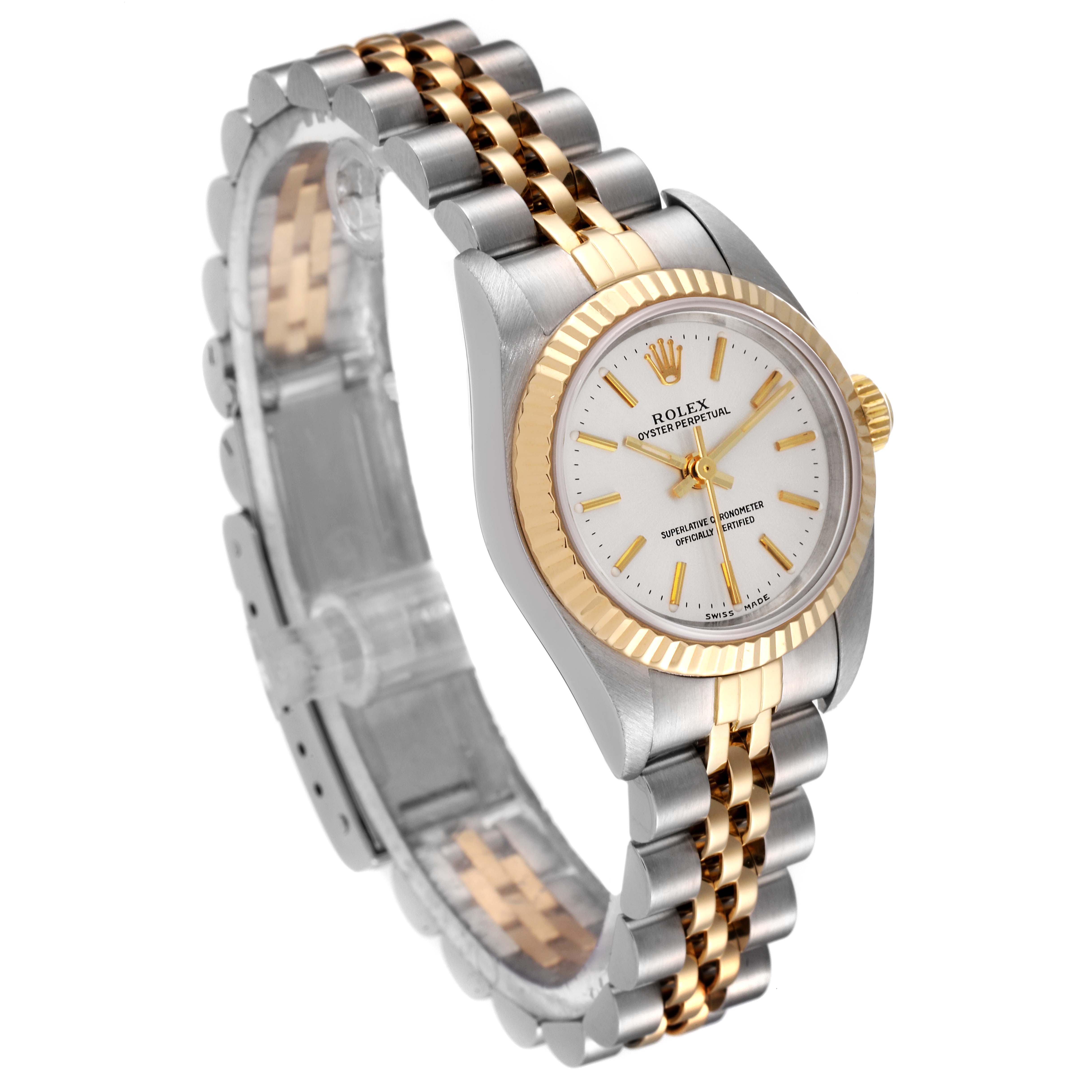 The image shows a side view of the Rolex Oyster Perpetual 76193 Women's Steel and Gold (two tone) Silver Dial 76193 Women's Steel and Gold (two tone) Silver Dial watch, highlighting its dial, fluted bezel, and two-tone bracelet.