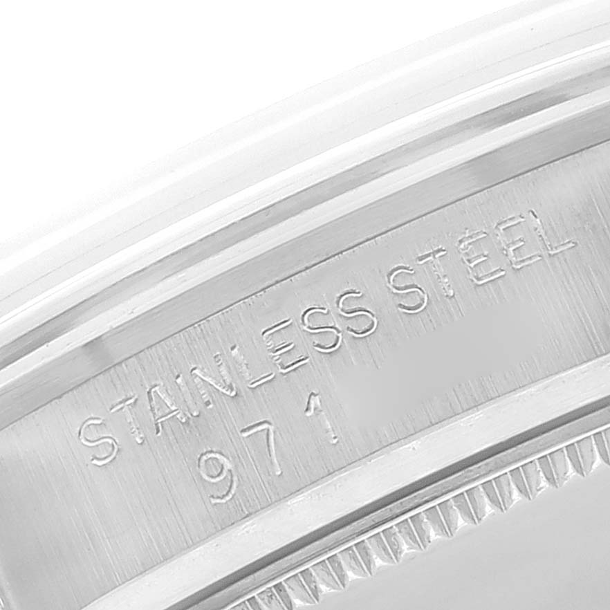 This close-up image of the Rolex Mid-Size 6466 Women's Stainless Steel Silver Dial 6466 Women's Stainless Steel Silver Dial watch shows the stainless steel inscription and part of the bezel.