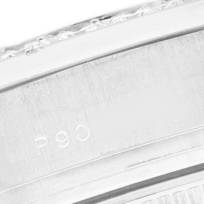 The image shows a close-up of a portion of the bezel and engravings on the Rolex Pearlmaster 80299 Women
s White Gold Mother of Pearl Dial watch.
