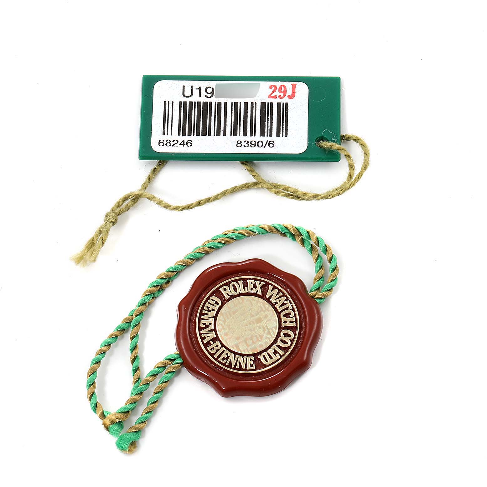 This image shows the tag and seal accessories for the Rolex President 68246 Women's Platinum Black Dial 68246 Women's Platinum Black Dial model watch.