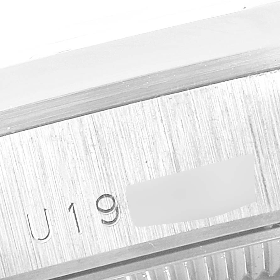 This close-up image shows the serial number engraving on the side of a Rolex President 68246 Women's Platinum Black Dial 68246 Women's Platinum Black Dial model watch.