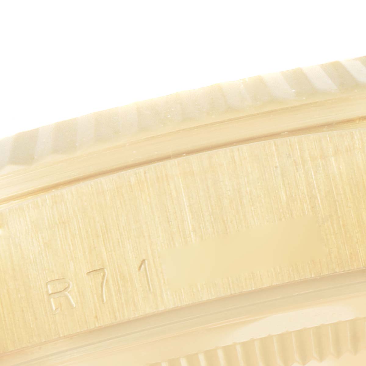 The image shows a close-up of the side of the bezel and case of the Rolex President 18238 Men
s Yellow Gold Champagne Dial 18238 Men
s Yellow Gold Champagne Dial watch, revealing part of its serial number.