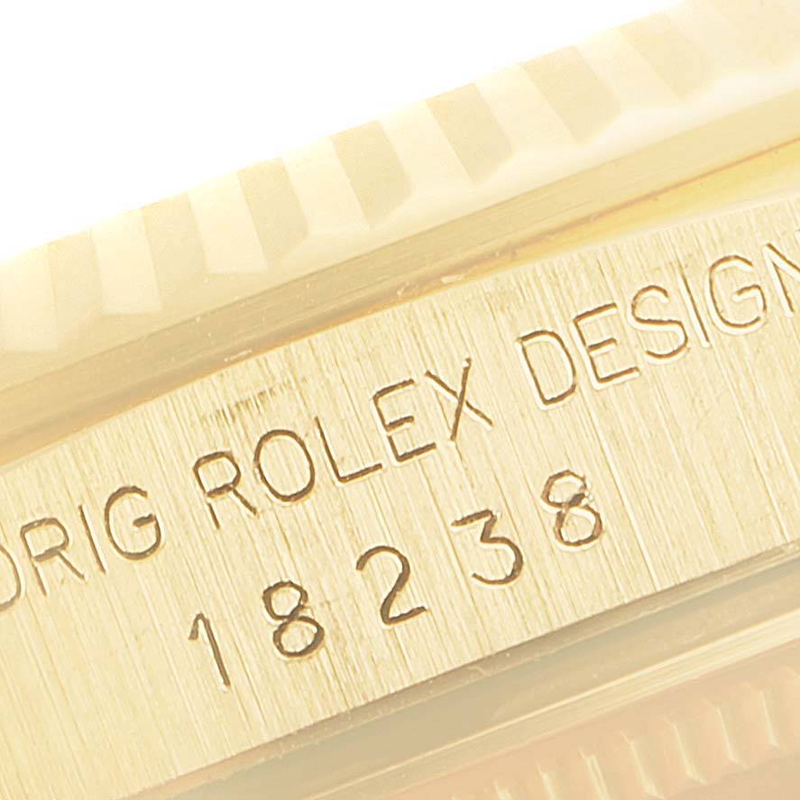 This close-up image shows the model and serial number engraving on the case of a Rolex President 18238 Men
s Yellow Gold Champagne Dial 18238 Men
s Yellow Gold Champagne Dial watch.