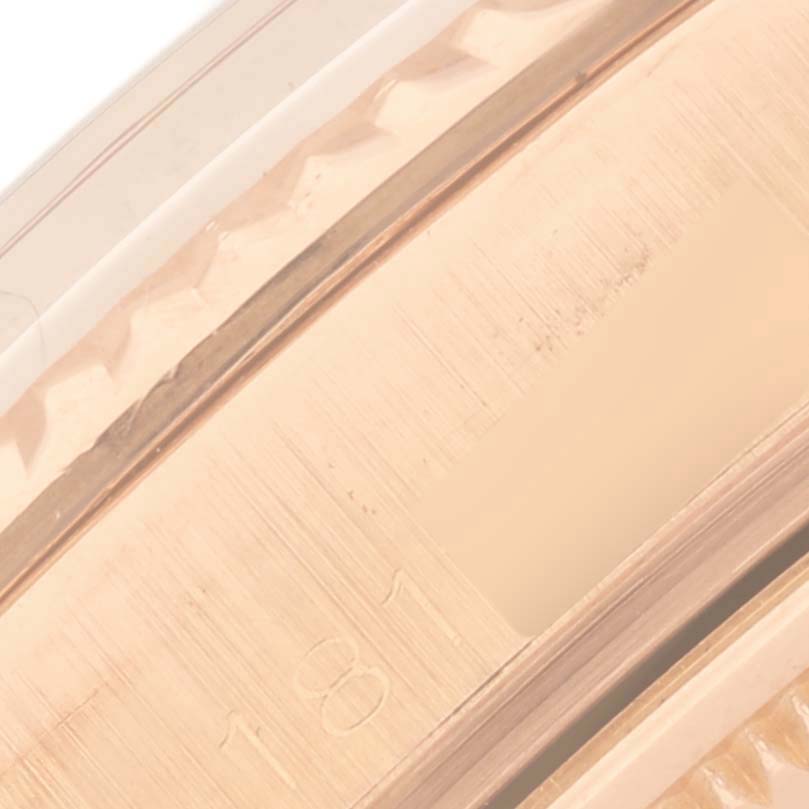 The image shows the side view of the Rolex President 1803 Men's Rose Gold Silver Dial 1803 Men's Rose Gold Silver Dial watch's gold casing and part of the fluted bezel.