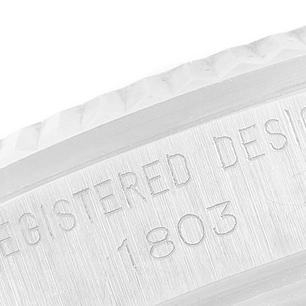 The image shows a close-up of the engraved side of a Rolex President 1803 Men's White Gold Black Dial 1803 Men's White Gold Black Dial model watch, highlighting its textured bezel and reference number.