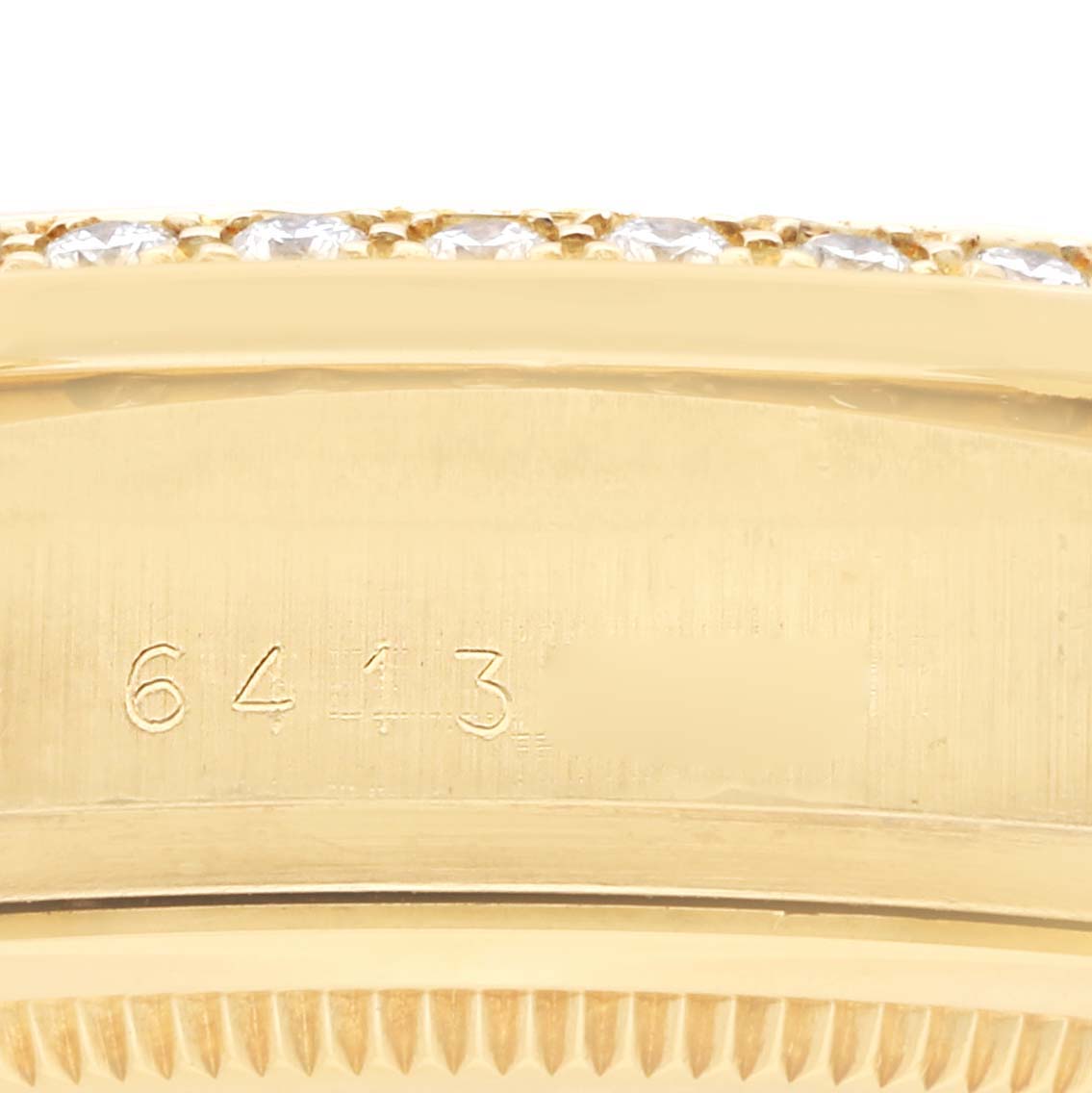 The image shows a close-up of the Rolex President 18048 Men
s Yellow Gold Champagne Dial model
s side, highlighting the bezel edge and engraved serial number.