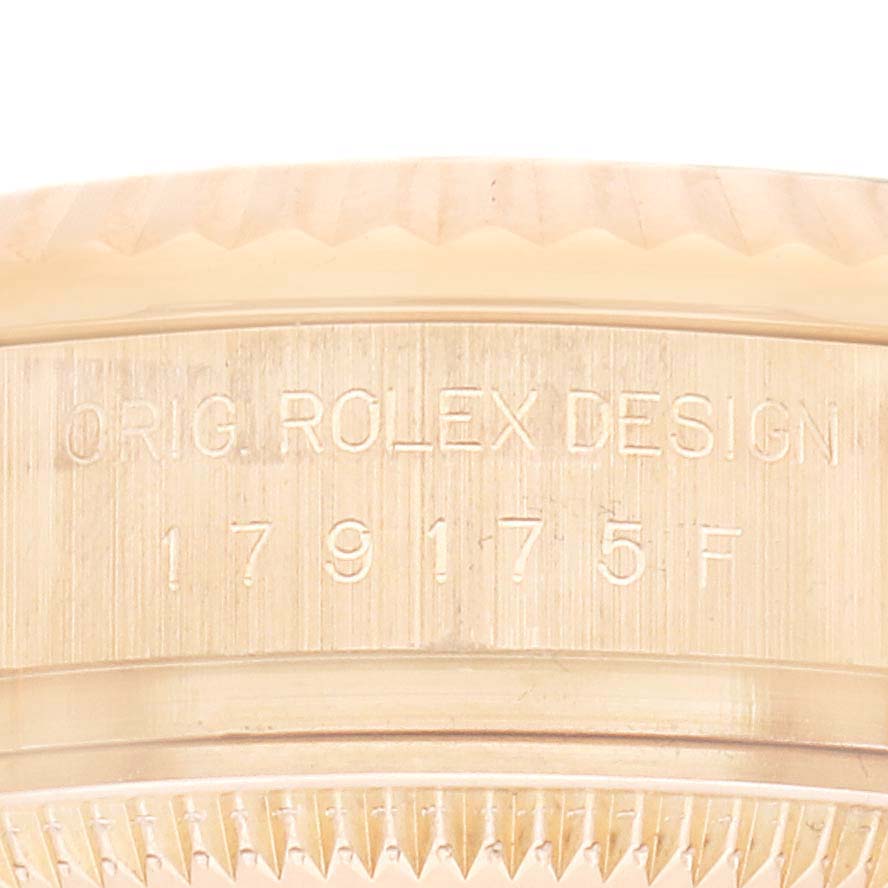 The image shows a close-up of the engraving on the side of a Rolex President 179175 Women
s Rose Gold Mother of Pearl Dial model watch case.