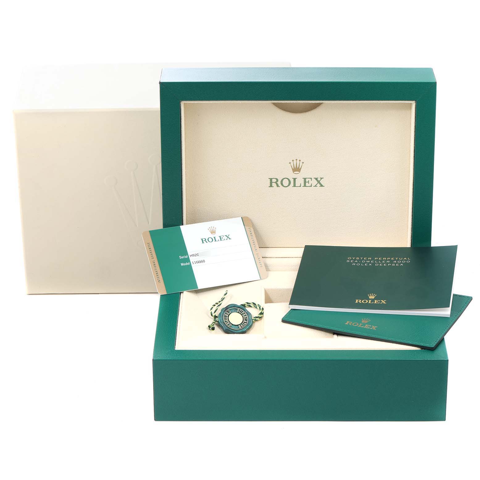 The image shows the packaging and accessories of a Rolex Sea-Dweller 116660 Men's Stainless Steel Blue Dial 116660 Men's Stainless Steel Blue Dial watch, including the watch box, manuals, and a tag.