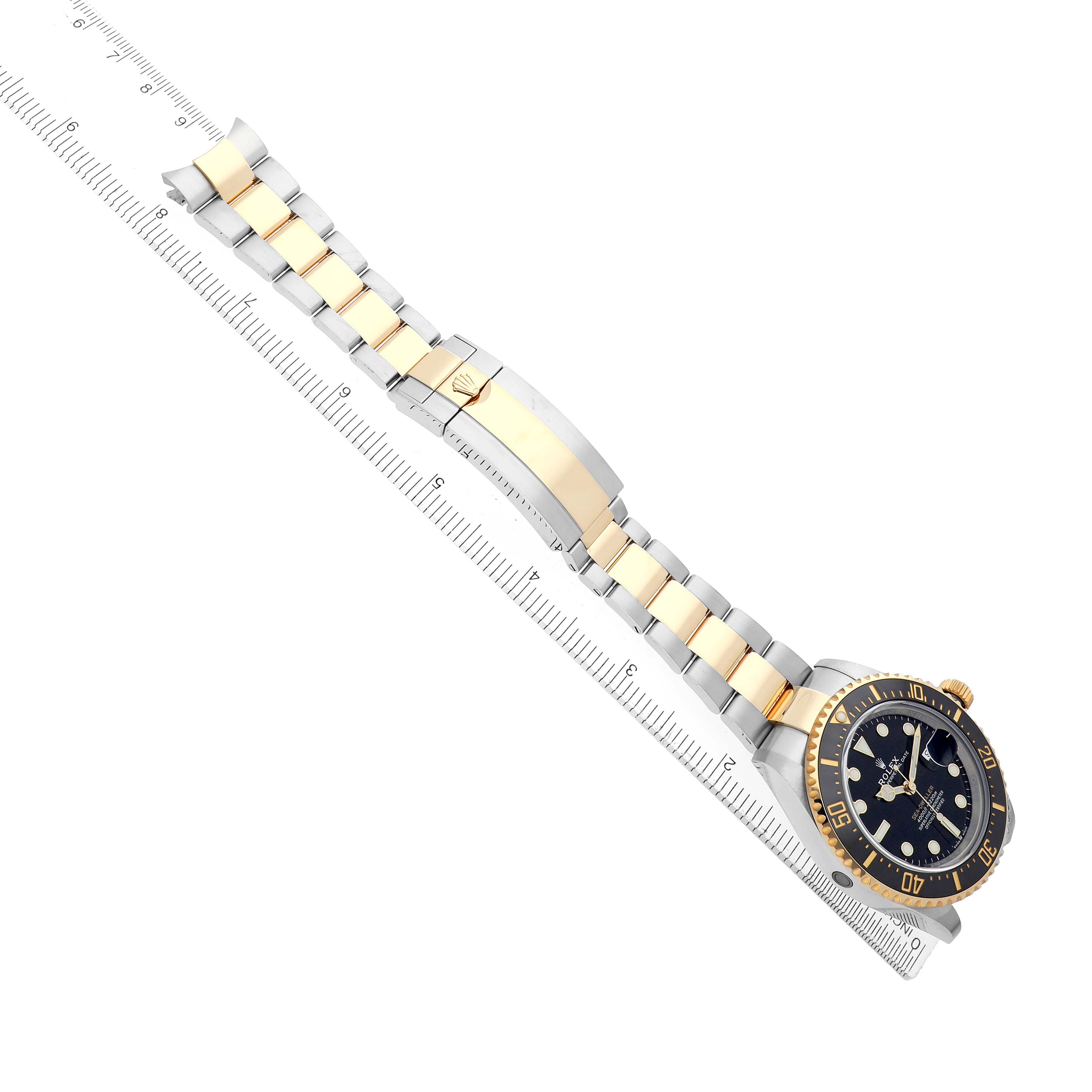 The Rolex Sea-Dweller 126603 Men
s Steel and Gold (two tone) Black Dial watch is shown at a diagonal angle, displaying the full bracelet, clasp, and face.