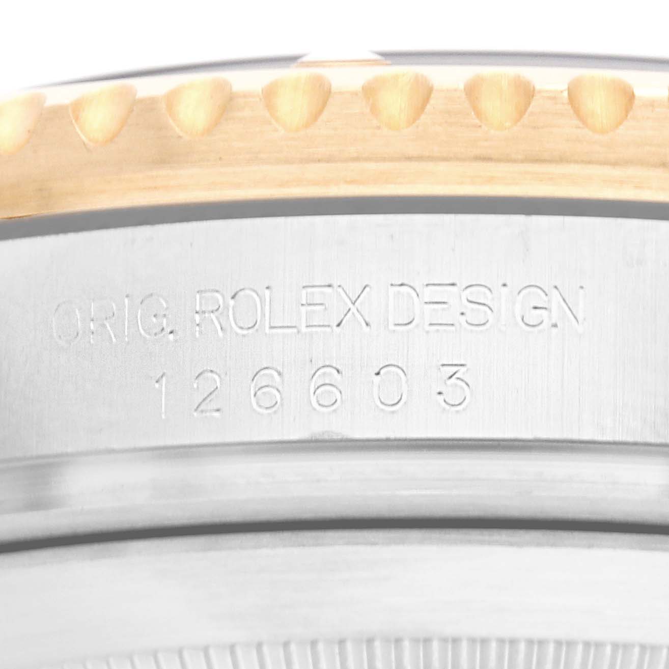 The image shows a close-up of the case edge and serial number engraving on a Rolex Sea-Dweller 126603 Men
s Steel and Gold (two tone) Black Dial watch.