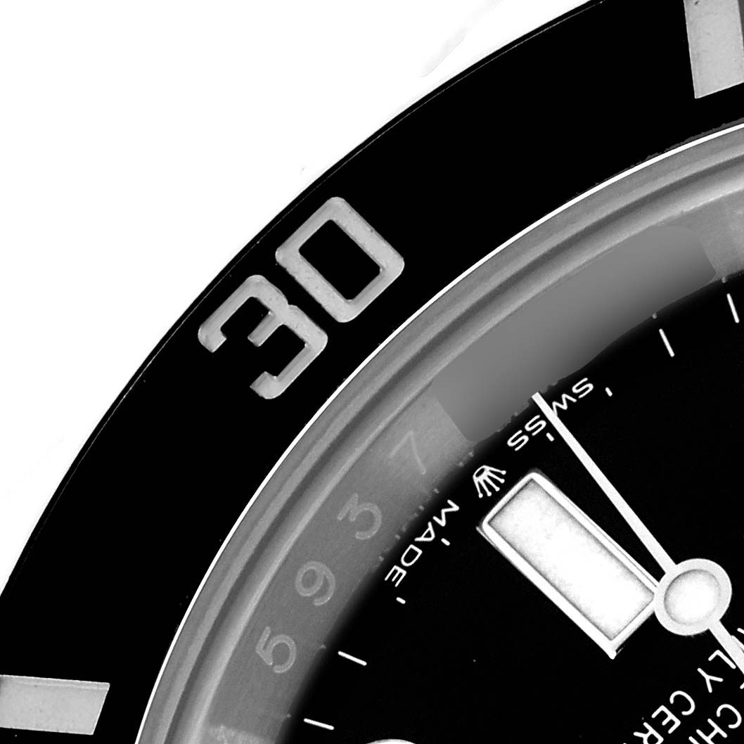 The image shows a close-up of the bezel and dial of a Rolex Submariner 126610 Men
s Stainless Steel Black Dial watch focusing on the "30" mark and part of the hands.