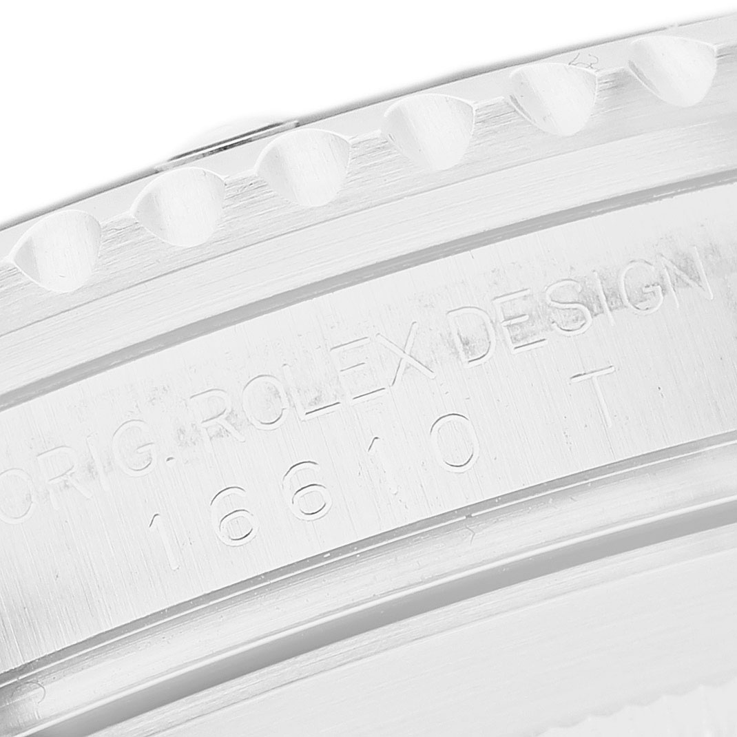 The image shows a close-up of the engraved case back design details of a Rolex Submariner 16610 Men's Stainless Steel Black Dial watch.
