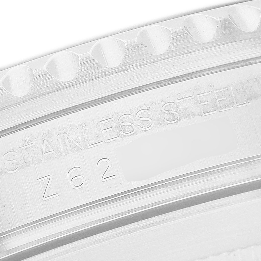 The image shows a close-up of the engraved side of a stainless steel Rolex Submariner 16610 Men's Stainless Steel Black Dial bezel.