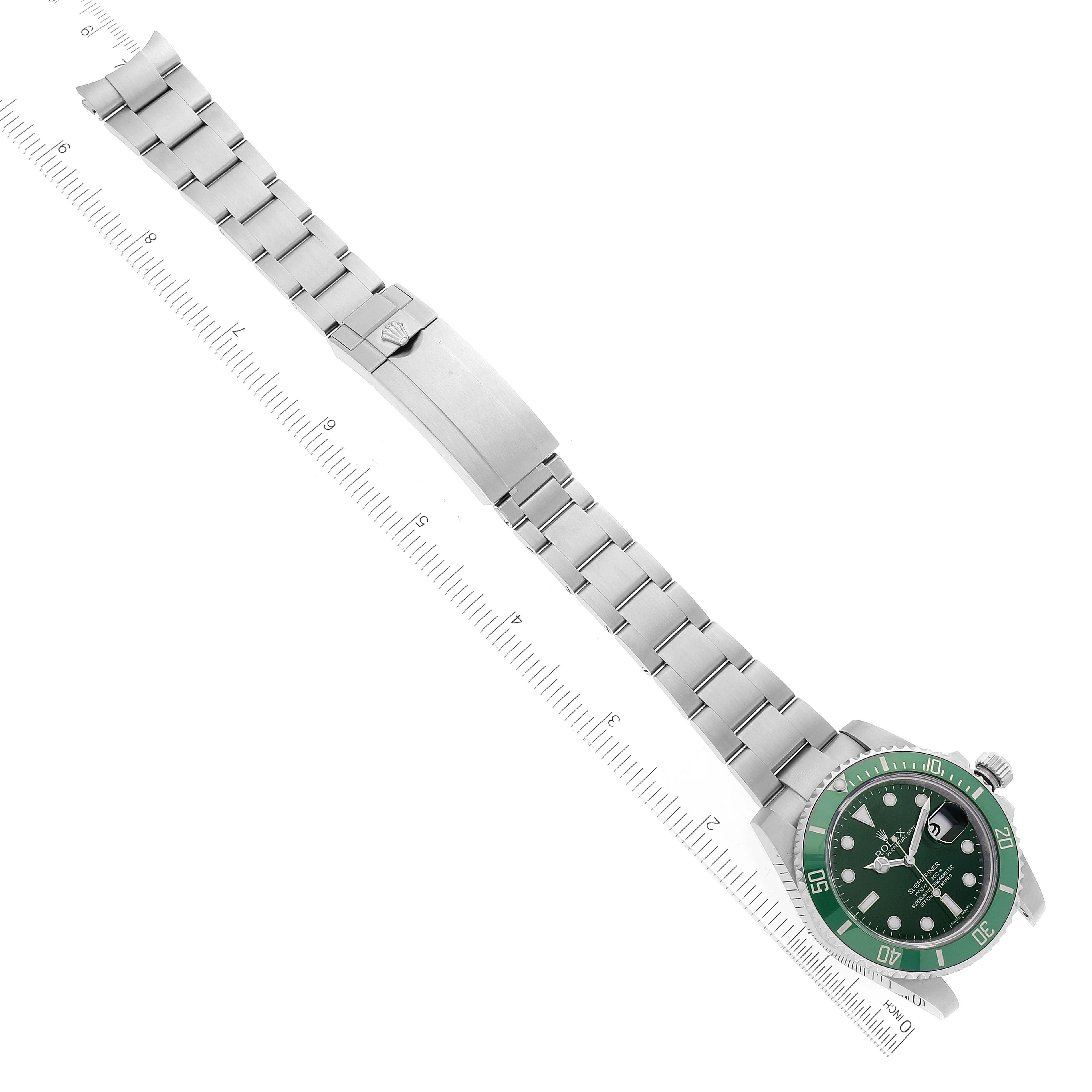 The image shows the Rolex Submariner 116610LV Men
s Stainless Steel Green Dial 116610LV Men
s Stainless Steel Green Dial watch laid flat with its green bezel, black dial, and stainless steel bracelet, viewed from above.