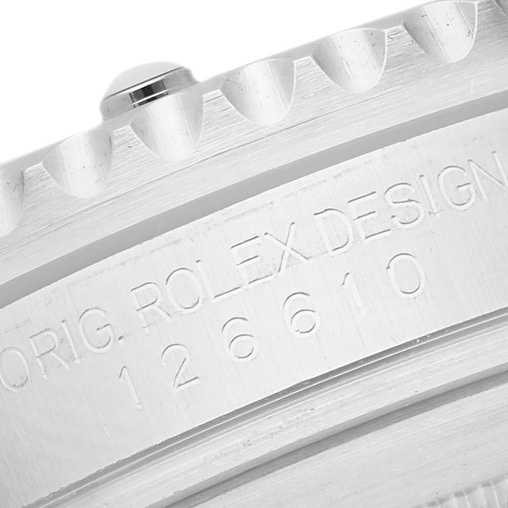 The image shows a close-up of the case and bezel edge of a Rolex Submariner 126610 Men
s Stainless Steel Black Dial, with engraved text visible.
