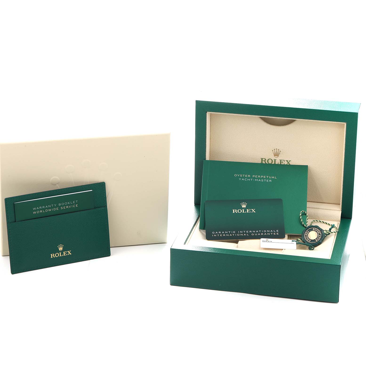 The image shows accessories for a Rolex Yacht-Master 126622 Men
s Stainless Steel Blue Dial, including a box, booklets, warranty card, and a tag, positioned from a side angle.
