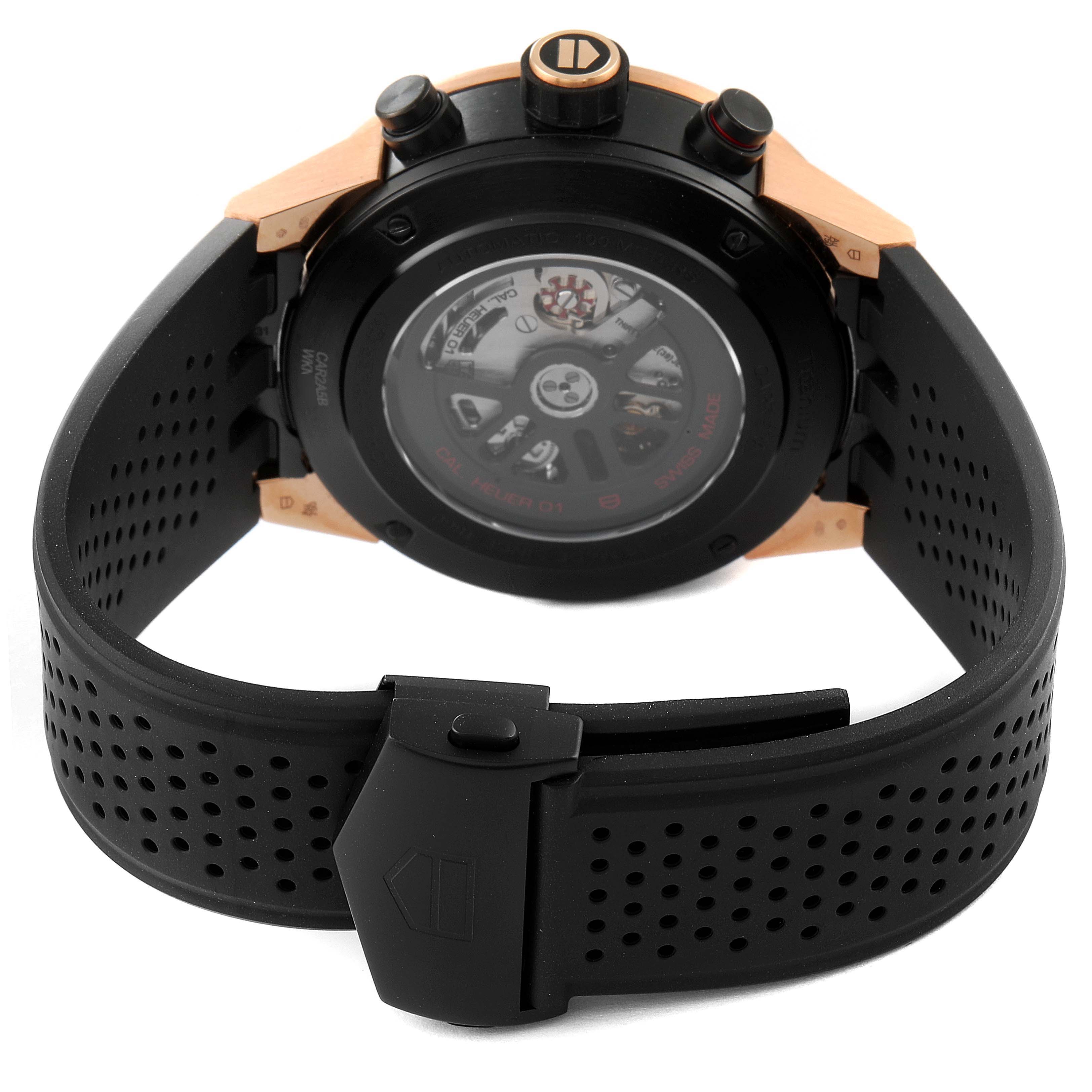 The image shows the back view of a Tag Heuer Carrera CAR2A5B.FT6044 Men's Titanium Black Dial CAR2A5B.FT6044 Men's Titanium Black Dial watch, highlighting its movement and black perforated rubber strap.