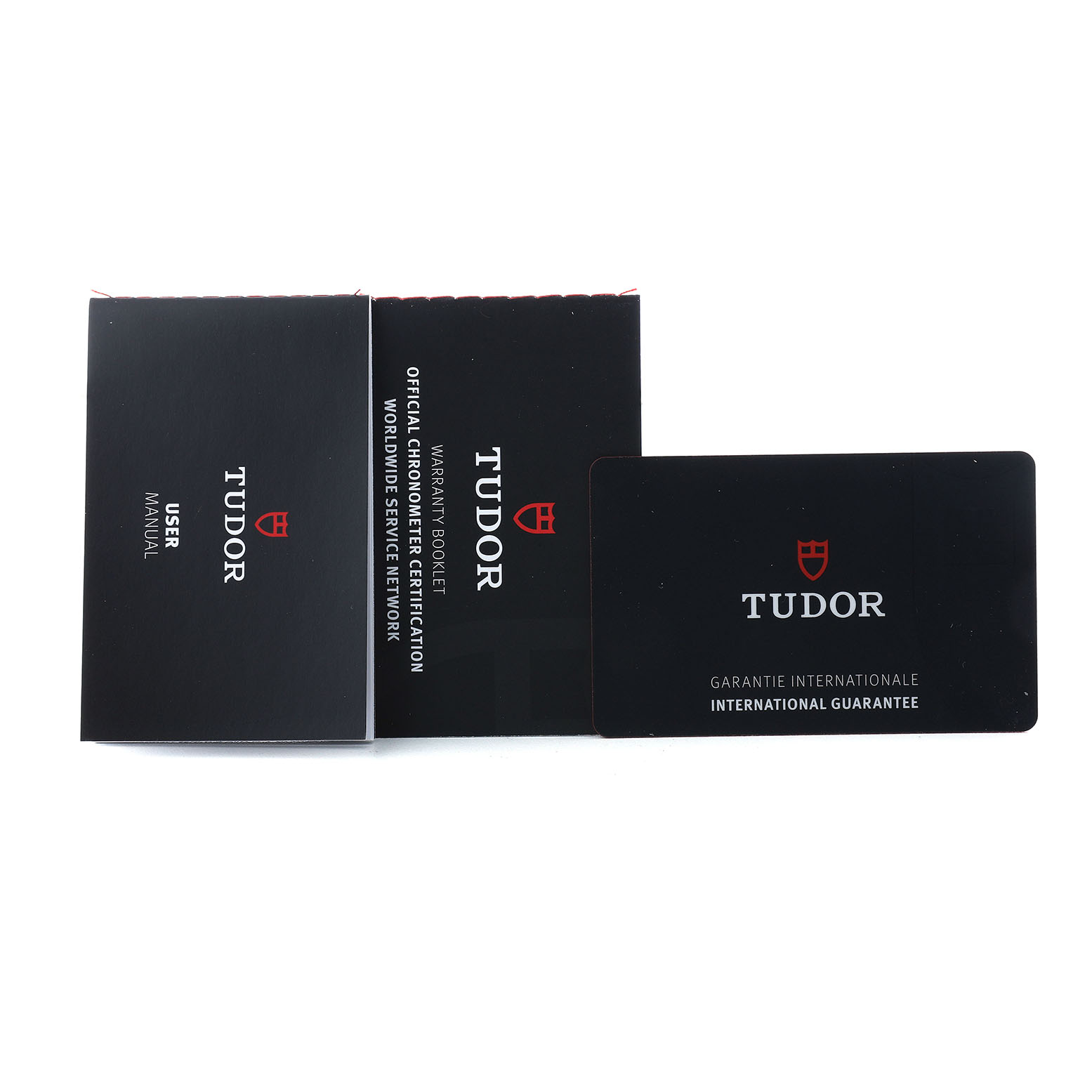 The image shows the user manual, warranty booklet, and international guarantee card for the Tudor Heritage Black Bay 7939G Men's Stainless Steel Black Dial model.