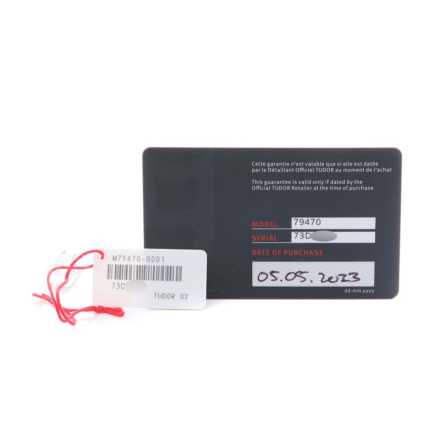 The image shows a warranty card and a tag for the Tudor Heritage Black Bay 79470 Men
s Stainless Steel Black Dial watch, displaying the model and serial numbers.