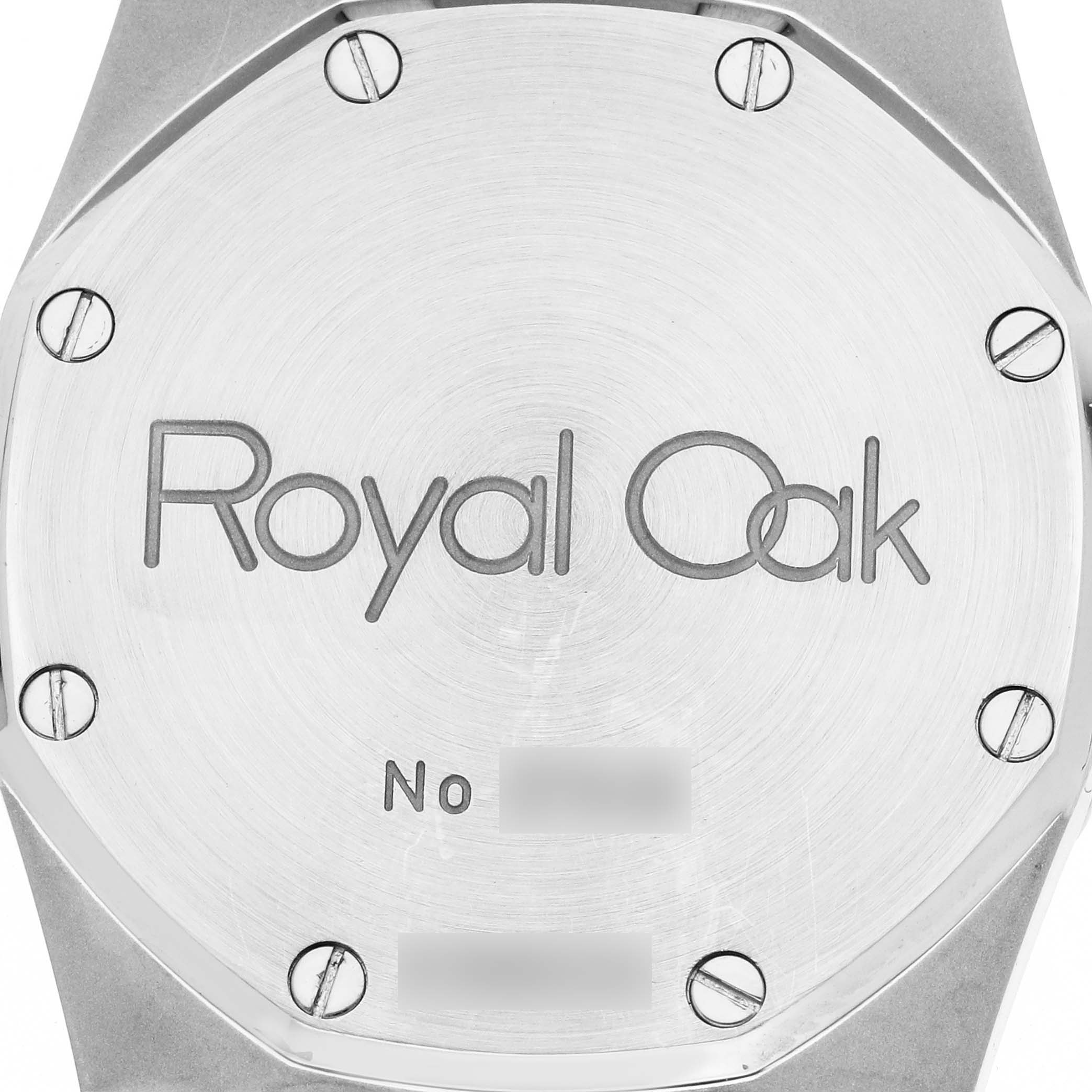 The image shows the case back of an Audemars Piguet Royal Oak 15000ST.OO.0789ST.05 Men
s Stainless Steel Blue Dial watch, displaying its screws and branding.