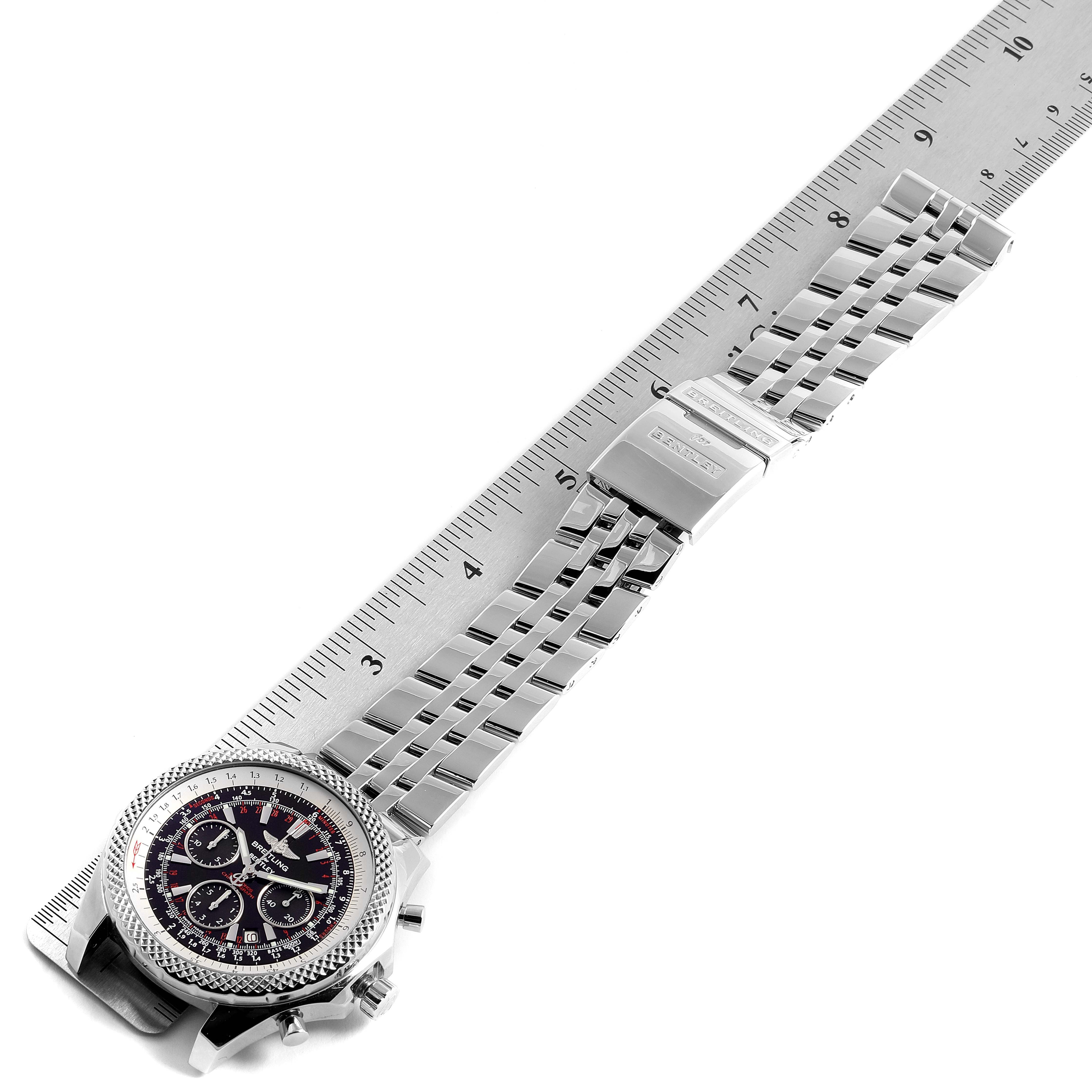 This image shows a Breitling Bentley A25362 Men's Stainless Steel Red Dial A25362 Men's Stainless Steel Red Dial watch laid flat, displaying its face, bezel, bracelet, and clasp, alongside a ruler for scale.