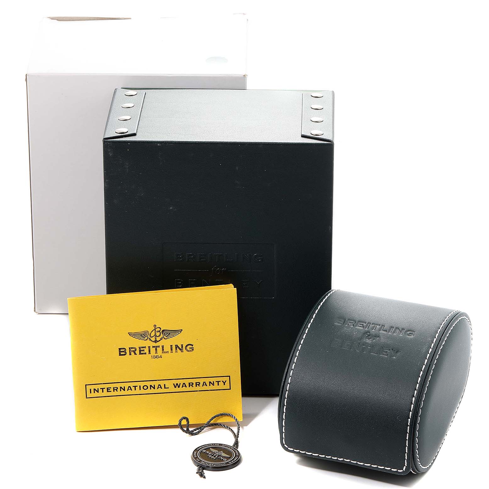 The image shows the packaging, warranty booklet, and carrying case for a Bentley model by Breitling.