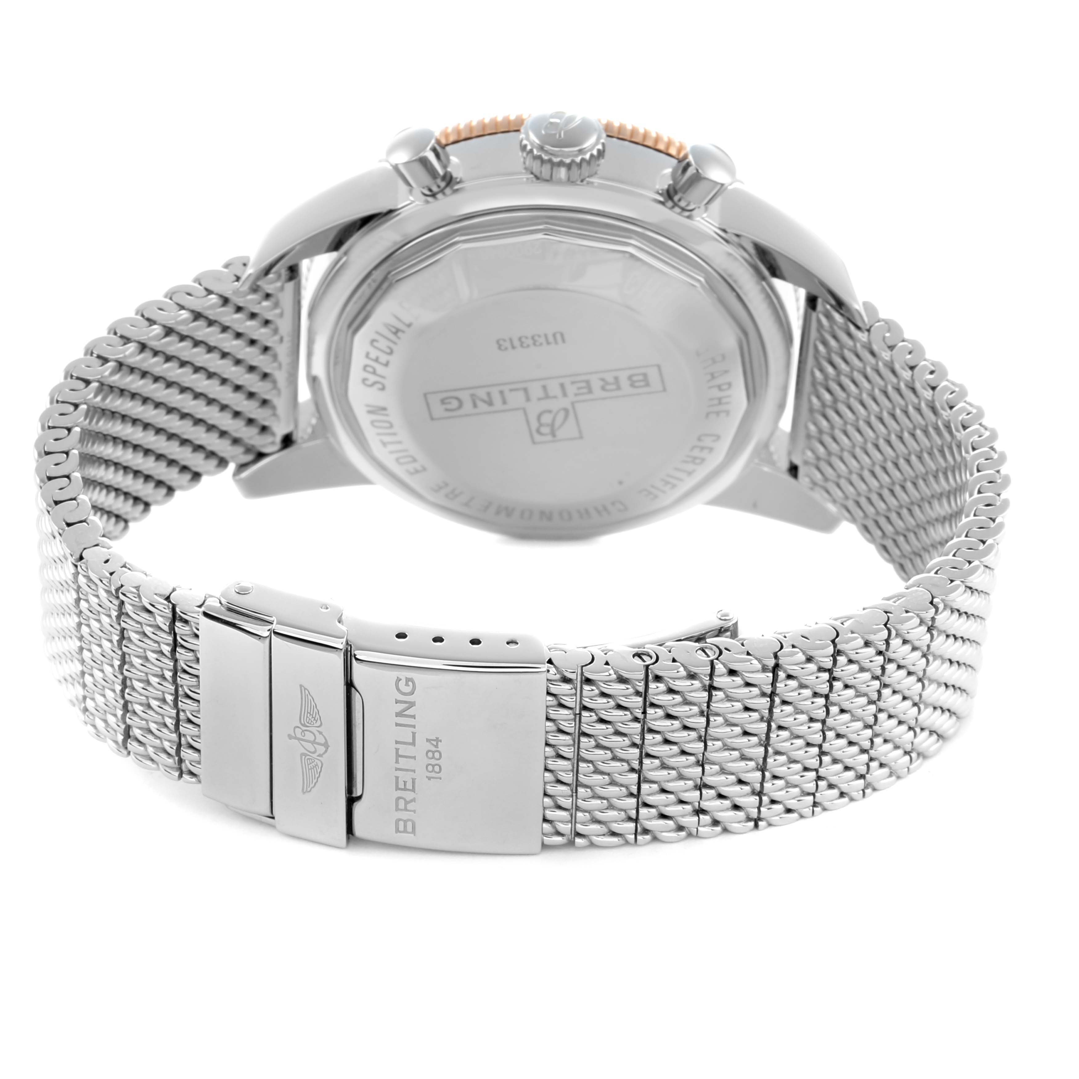 The Breitling Superocean U13313 Men
s Stainless Steel Black Dial watch is shown from the back, highlighting its clasp, case back, and mesh bracelet.