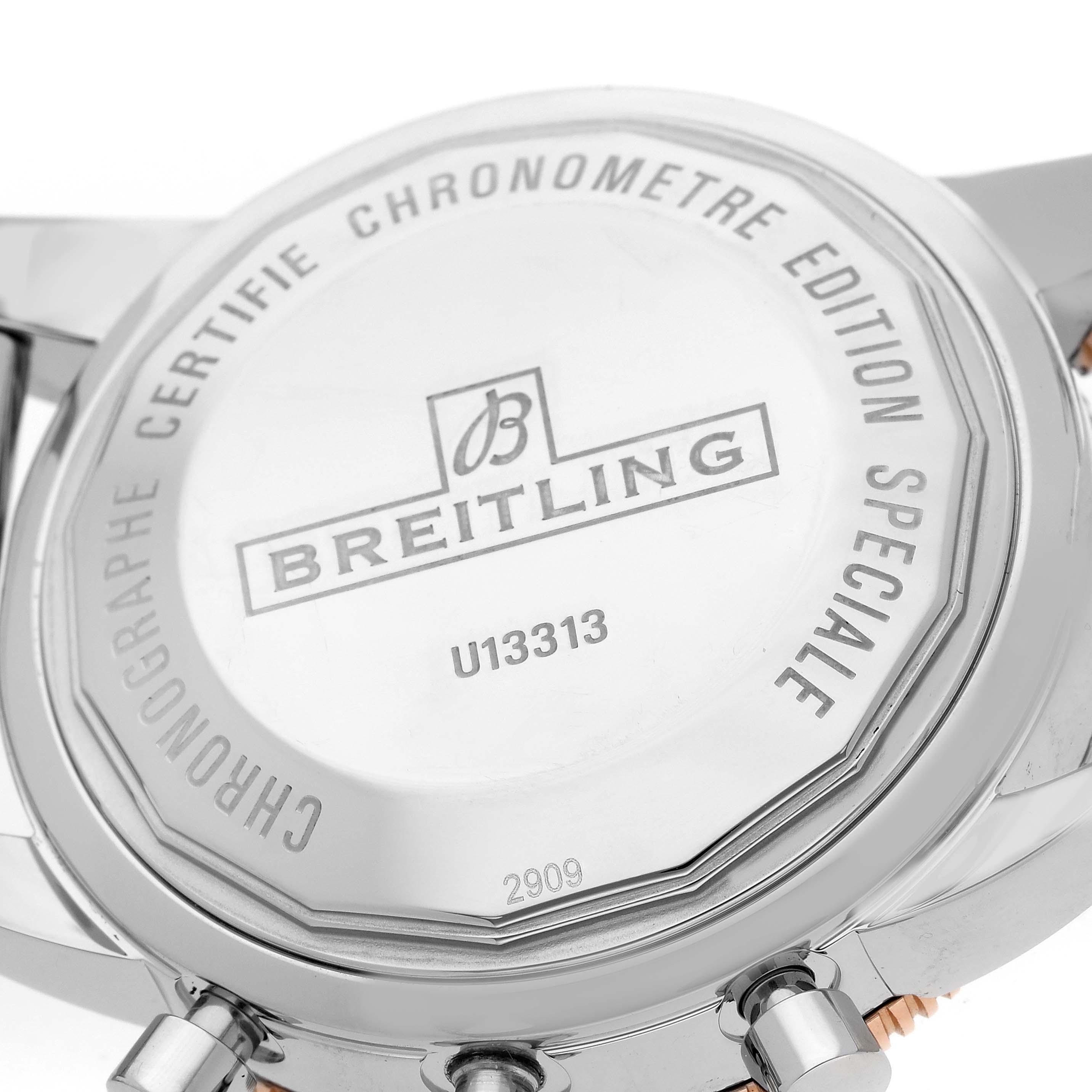 The image shows the case back of a Breitling Superocean U13313 Men
s Stainless Steel Black Dial watch, highlighting engravings and pushers.