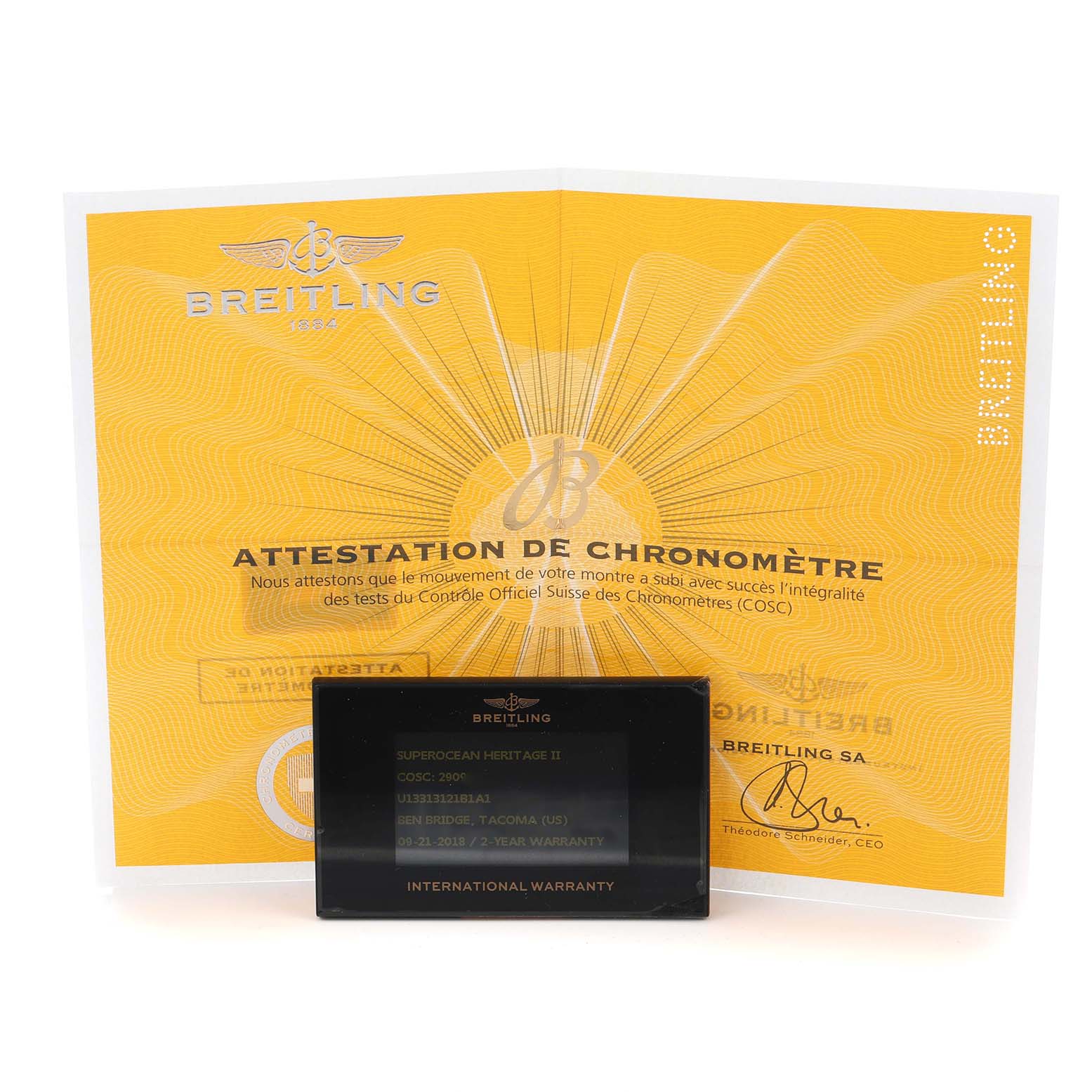 The image shows a Breitling Superocean U13313 Men
s Stainless Steel Black Dial warranty card and chronometer certificate, both displayed from the front.