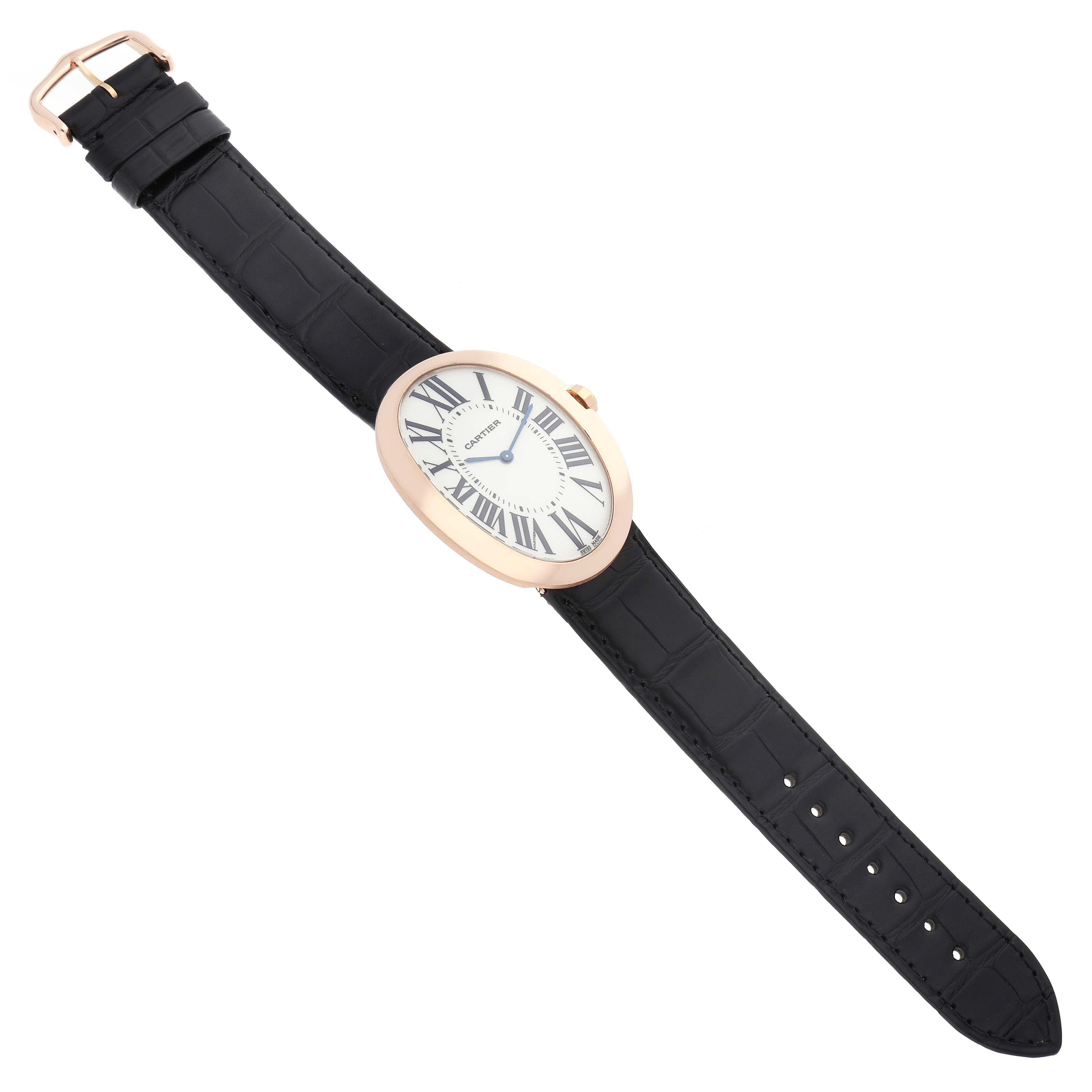 The Cartier Baignoire W852000002 Women
s Rose Gold Silver Dial watch is shown from a top view, displaying the oval face, strap, buckle, and Roman numerals.