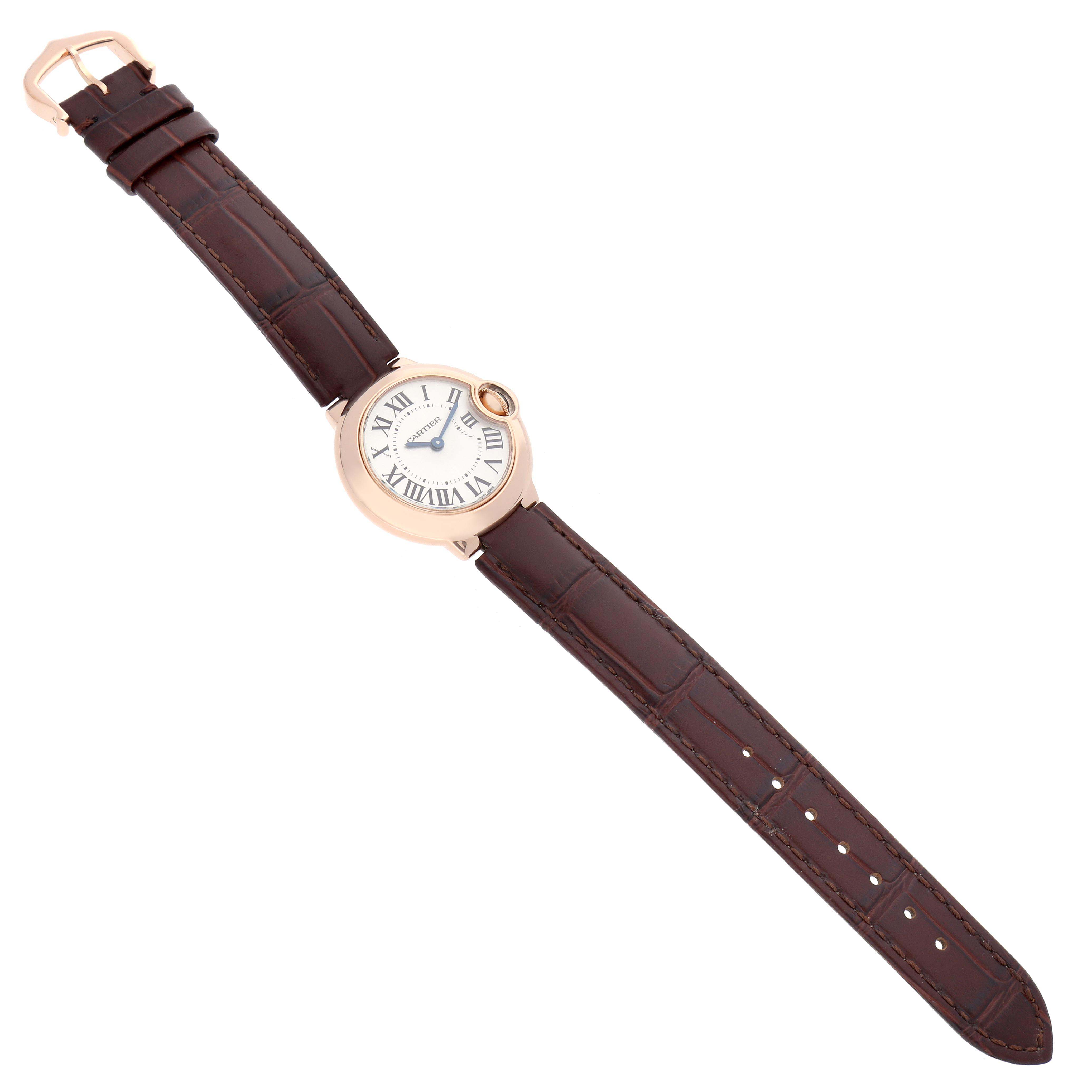 The Cartier Ballon Bleu W6900256 Women's Rose Gold Silver Dial watch is shown at an angled top view, displaying its face, crown, and the full leather strap.