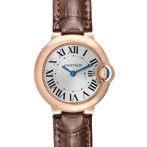 The Cartier Ballon Bleu W6900256 Women's Rose Gold Silver Dial watch is shown from a front angle, displaying the dial, blue hands, Roman numerals, and brown leather strap.