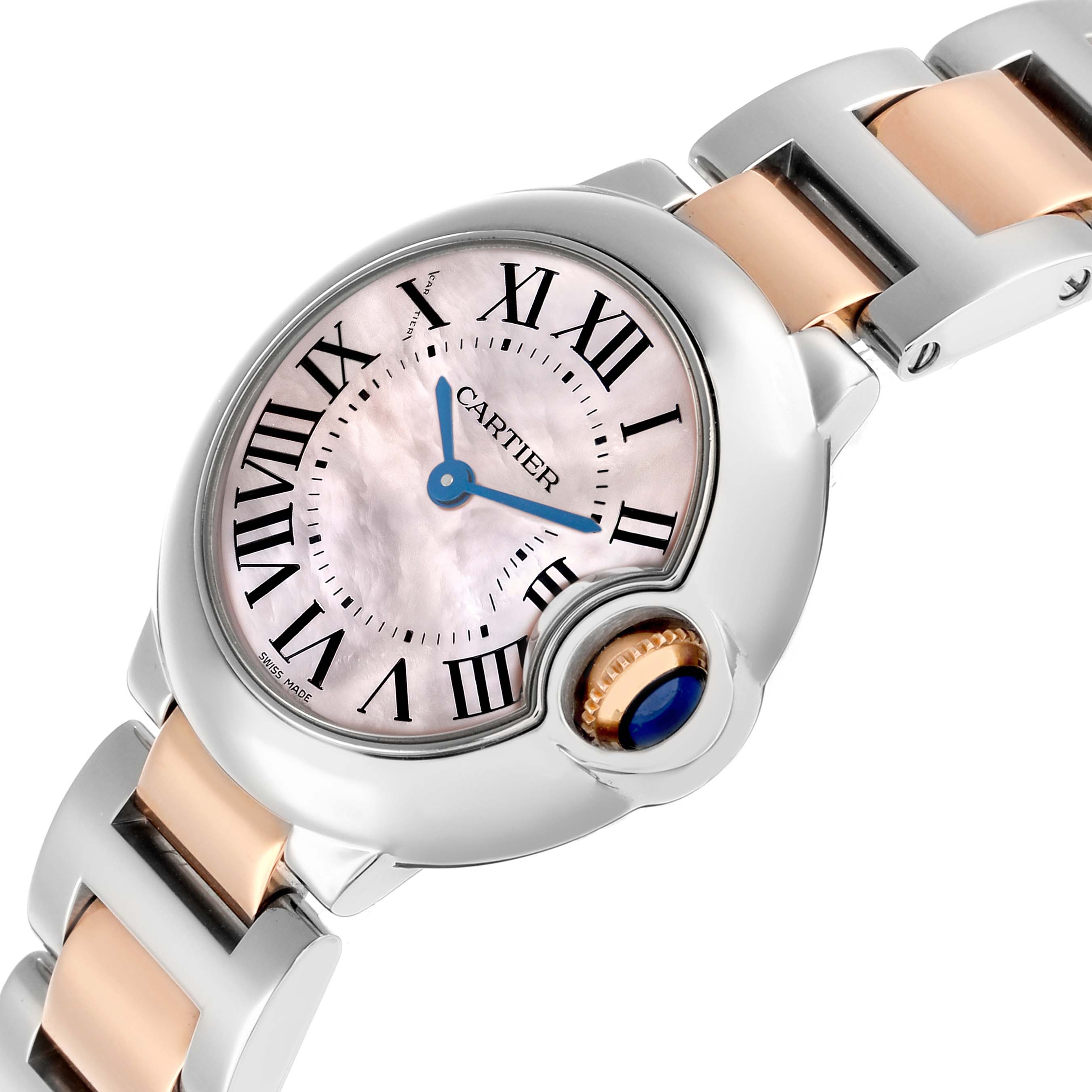 The Ballon Bleu de Cartier watch is shown at a tilted angle, highlighting the dial, crown, and part of the bracelet.