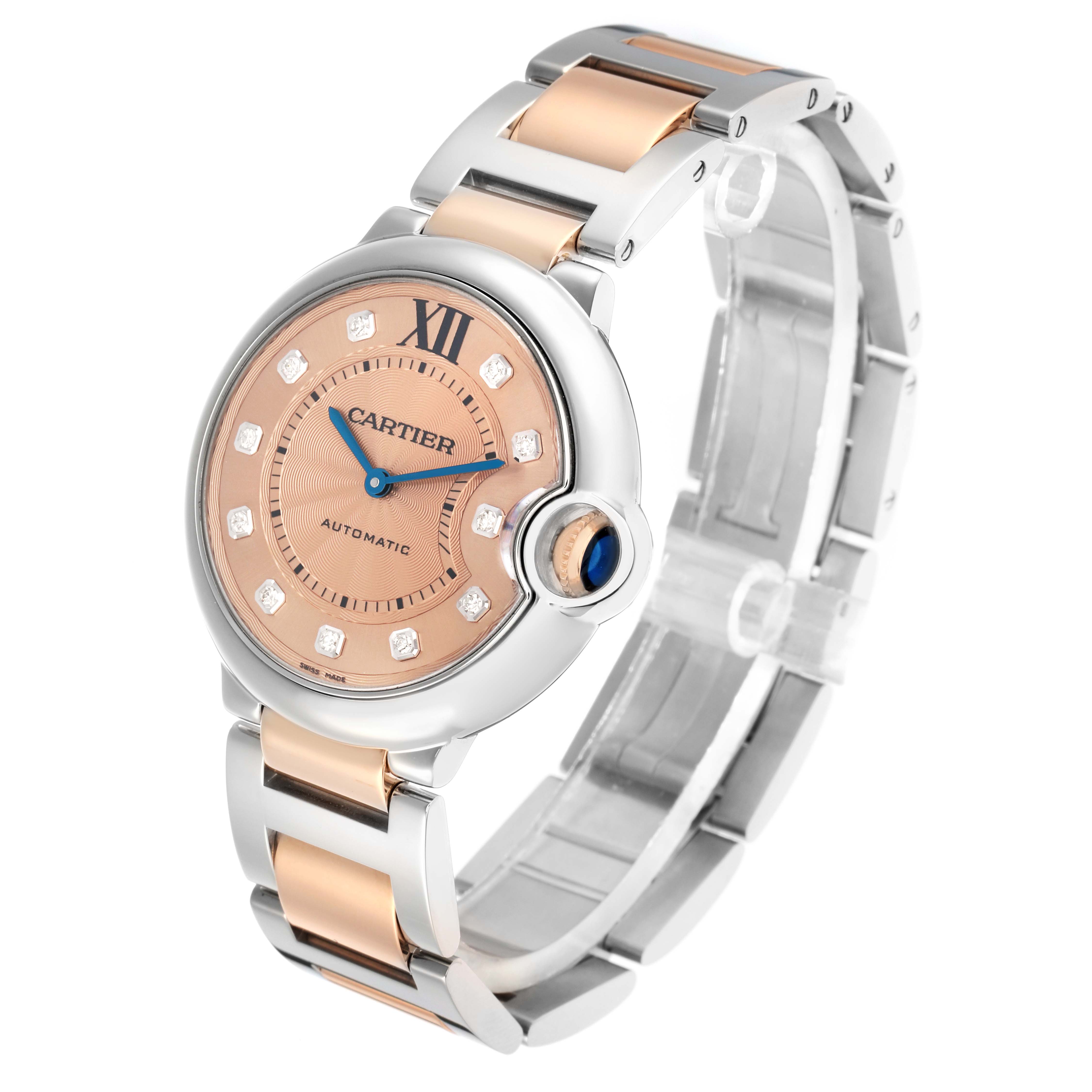 The Cartier Ballon Bleu WE902054 Women's Steel and Gold (two tone) Pink Dial watch is shown at a three-quarter angle, displaying its full face, crown, and part of the bracelet.