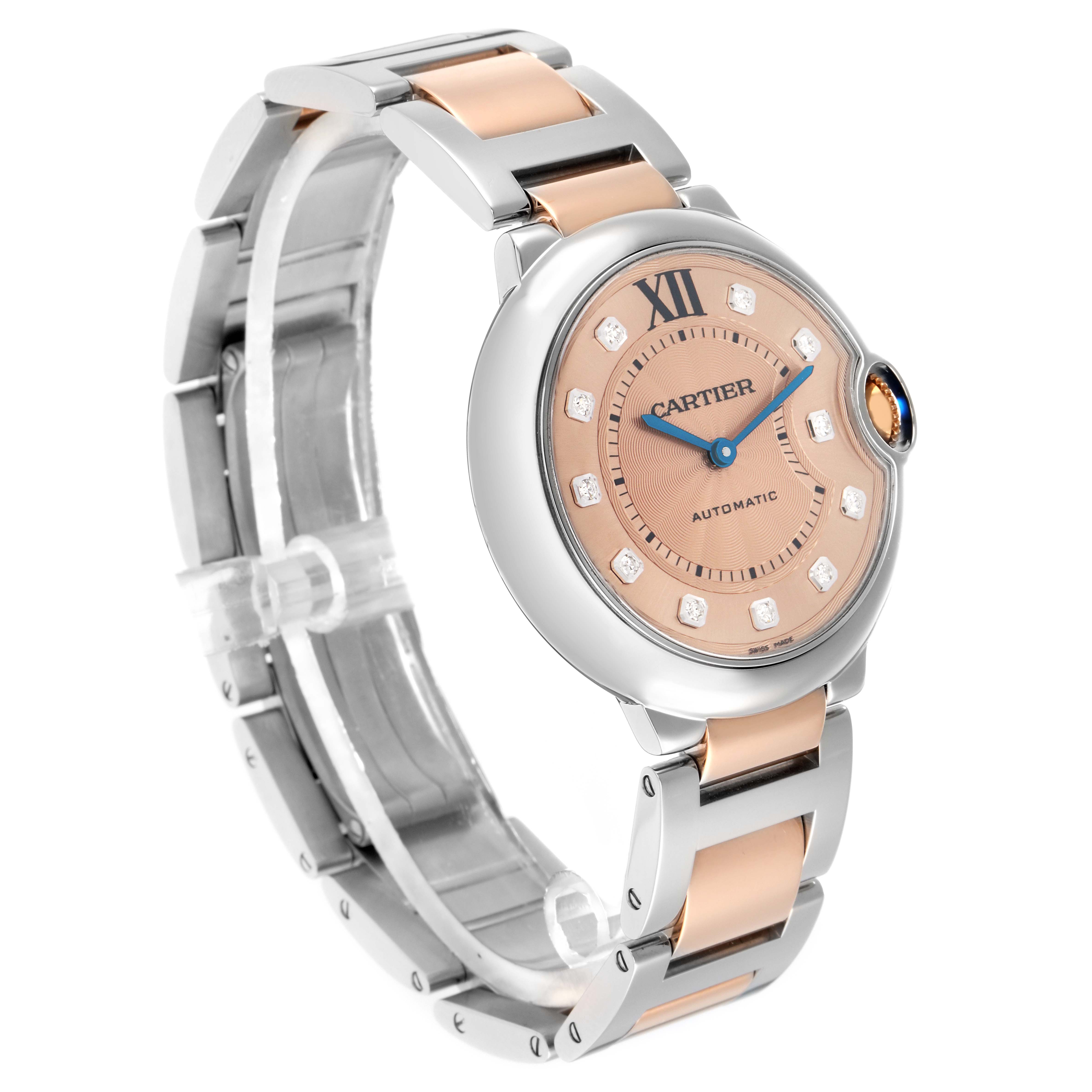 The Cartier Ballon Bleu WE902054 Women's Steel and Gold (two tone) Pink Dial watch is shown at a three-quarter angle, highlighting its round face, crown, and two-tone bracelet.